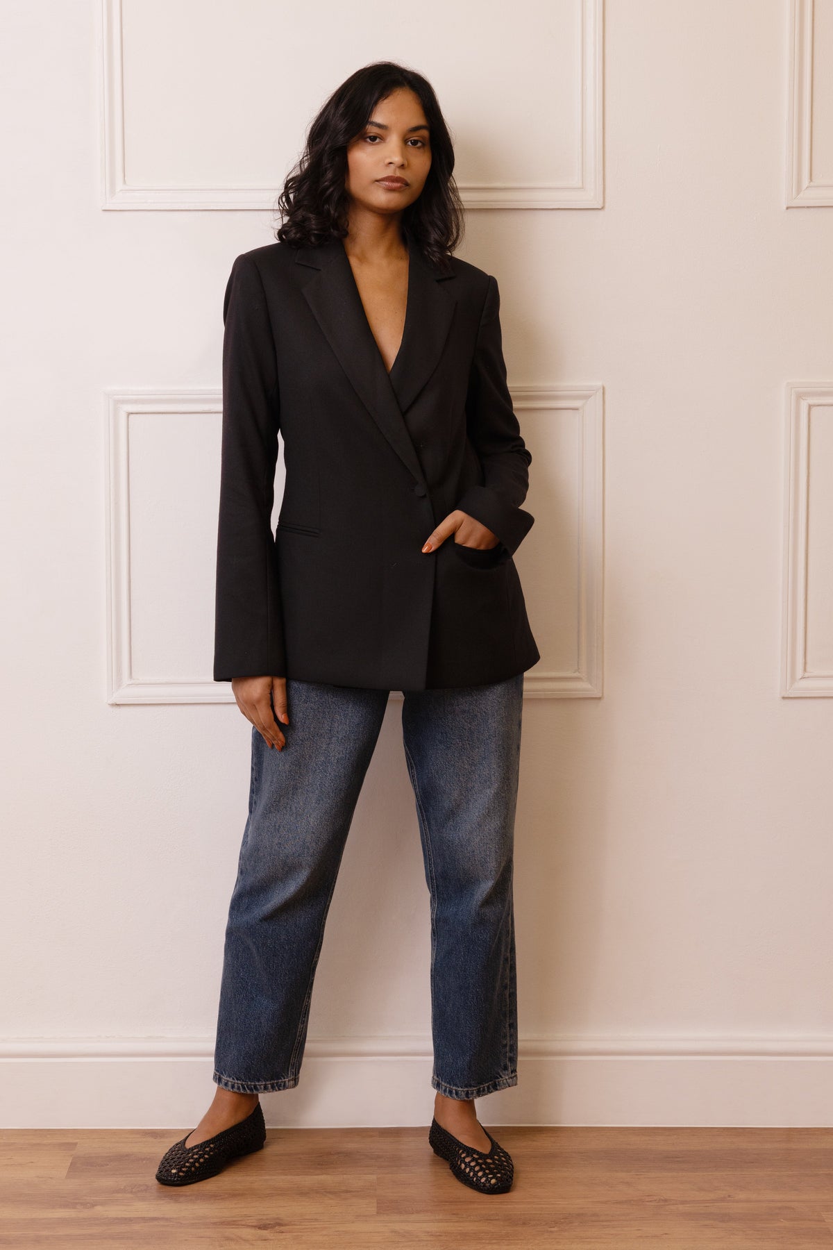 The Josephine wool blend blazer in black with blue jeans and black flats, two foundations of an autumn capsule wardrobe