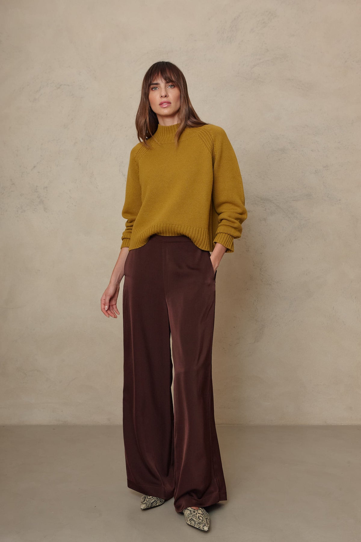 The Hazel wide leg satin trousers in chocolate with the Blythe funnel neck cropped jumper in turmeric