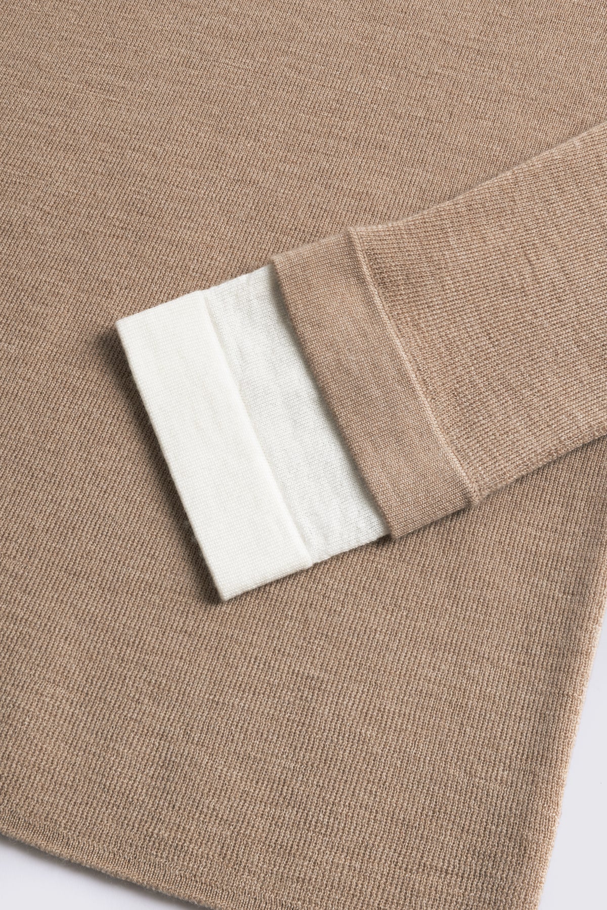 Camel merino crew neck jumper with an ivory cuff, shown flat