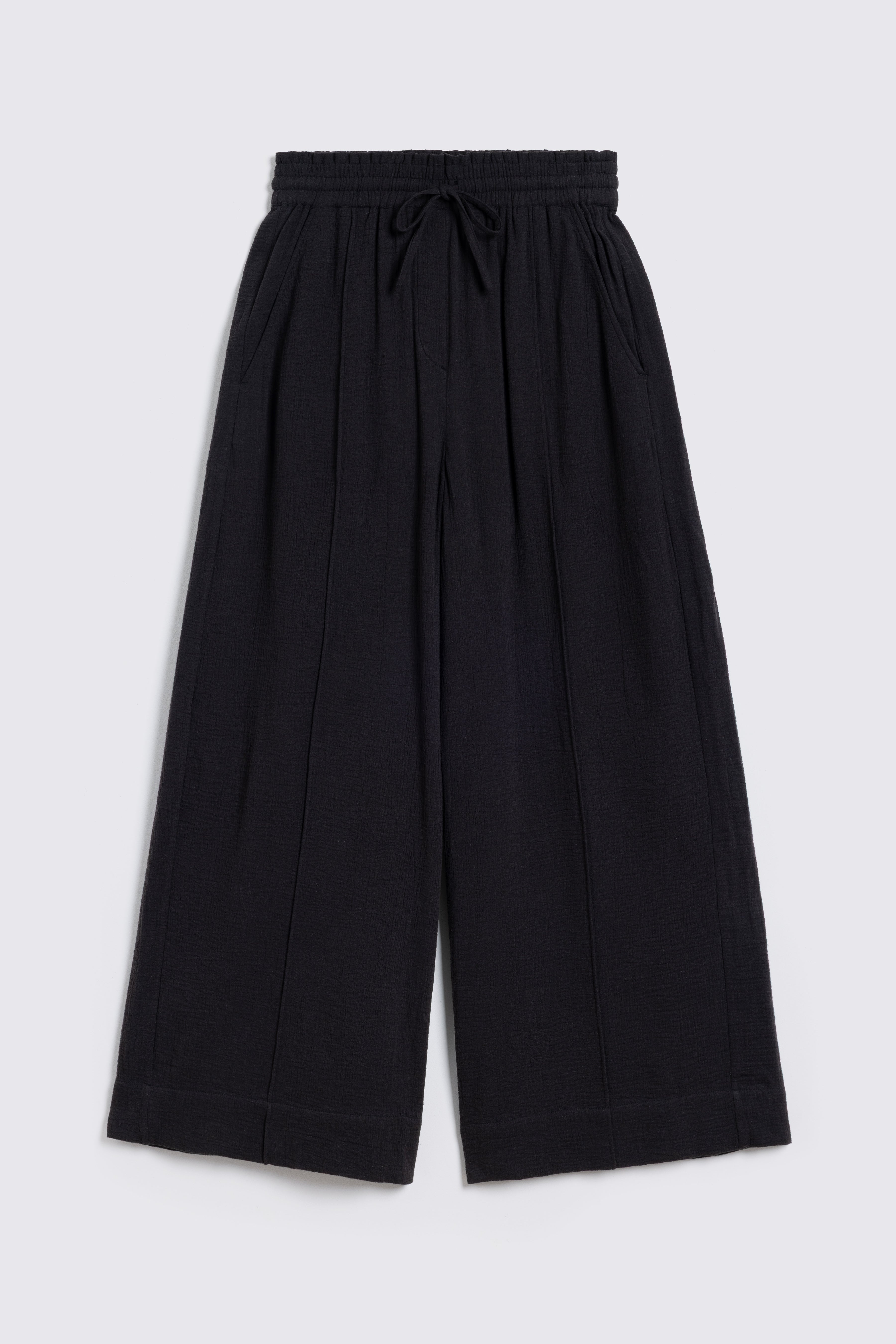 Black cheesecloth trousers on white background