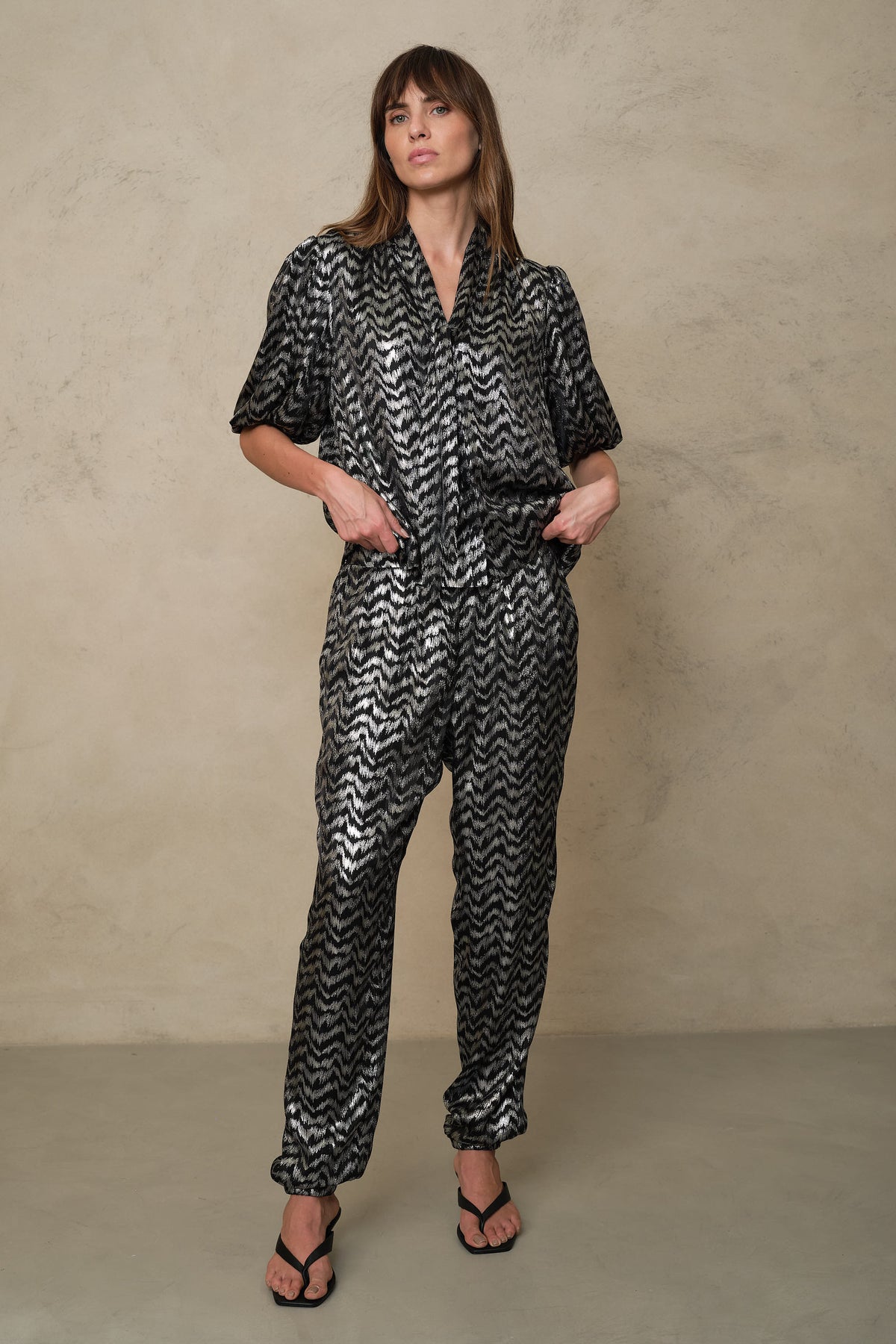 Florence silver trousers styled as a full co-ord with the matching metallic blouse