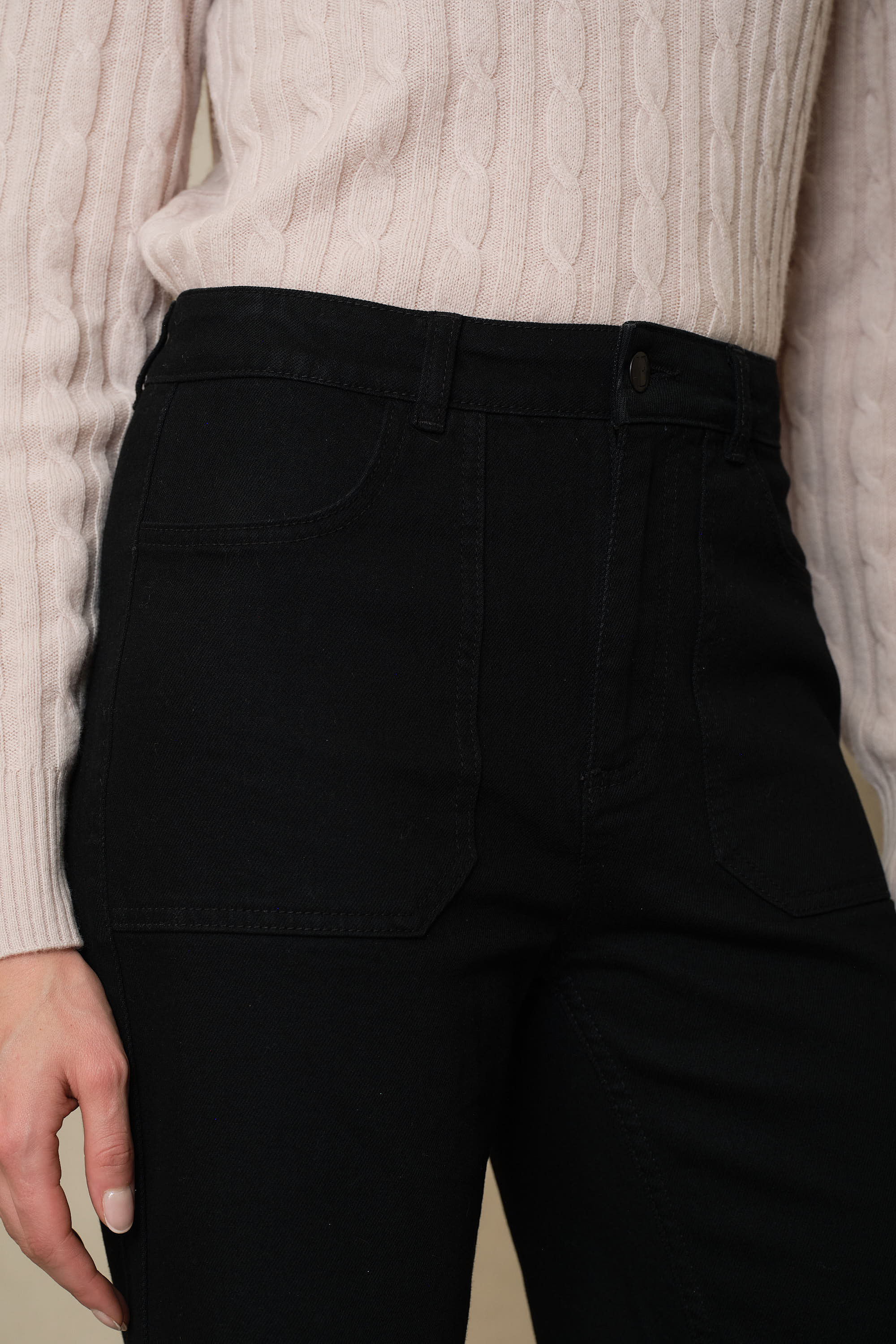 Close detail of the Frankie black jeans, showing the carpenter style patch pockets and zip fly