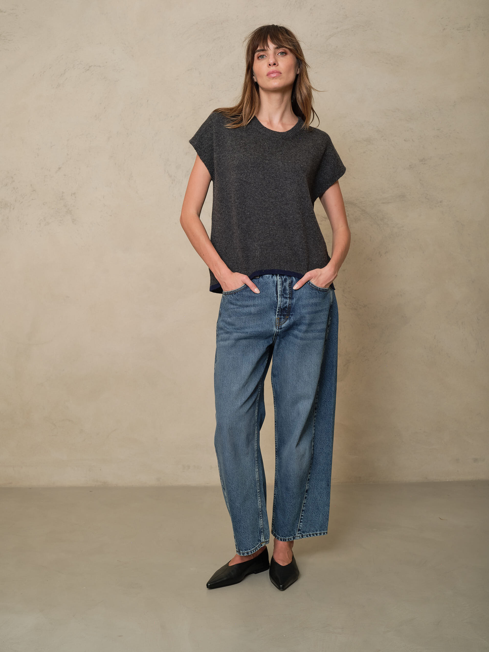 Rosie mid wash twist front jeans styled with a charcoal knitted T Shirt, front view