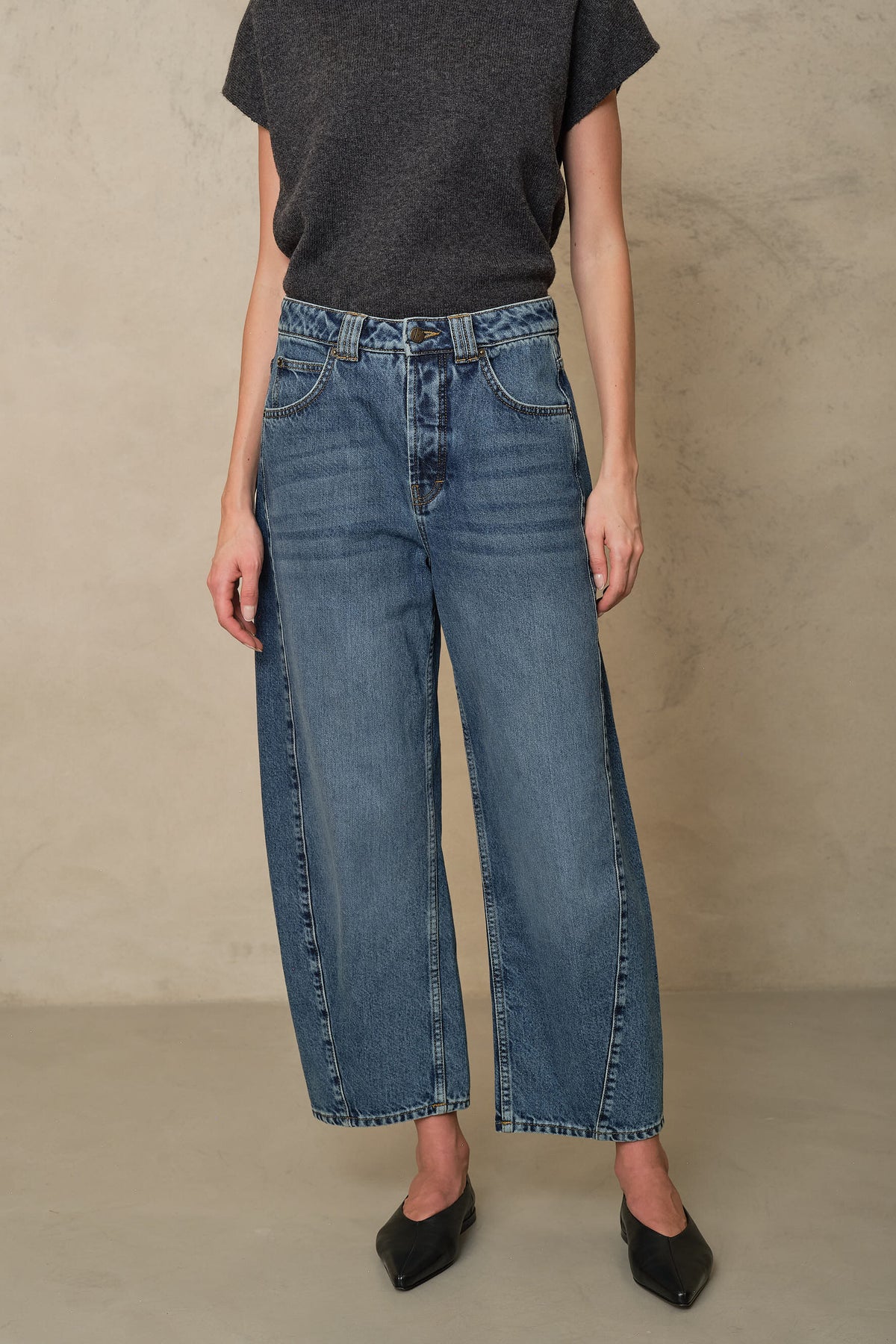 Rosie mid wash twist front jeans worn with a charcoal T Shirt and black flats