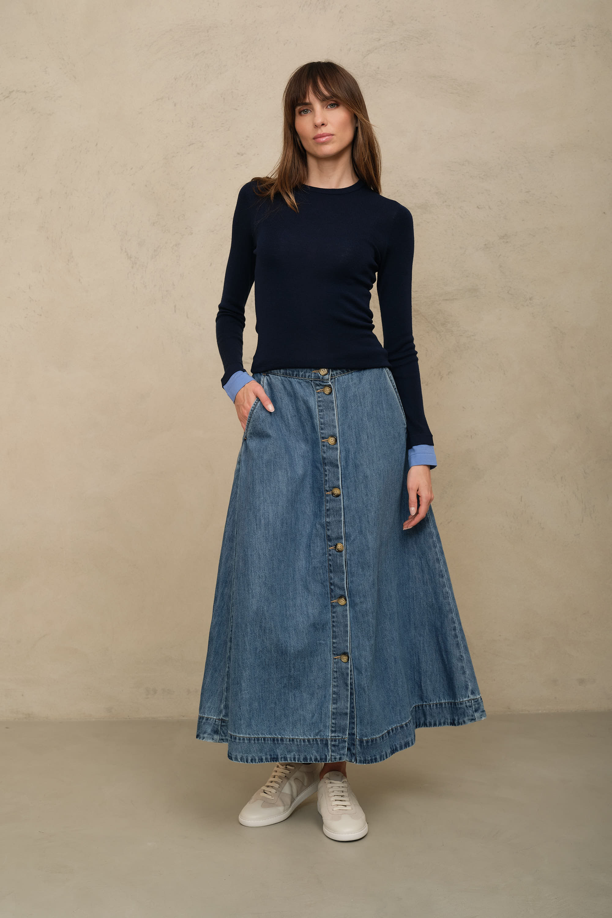 Imogen mid wash denim skirt styled with a navy fine knit and white trainers