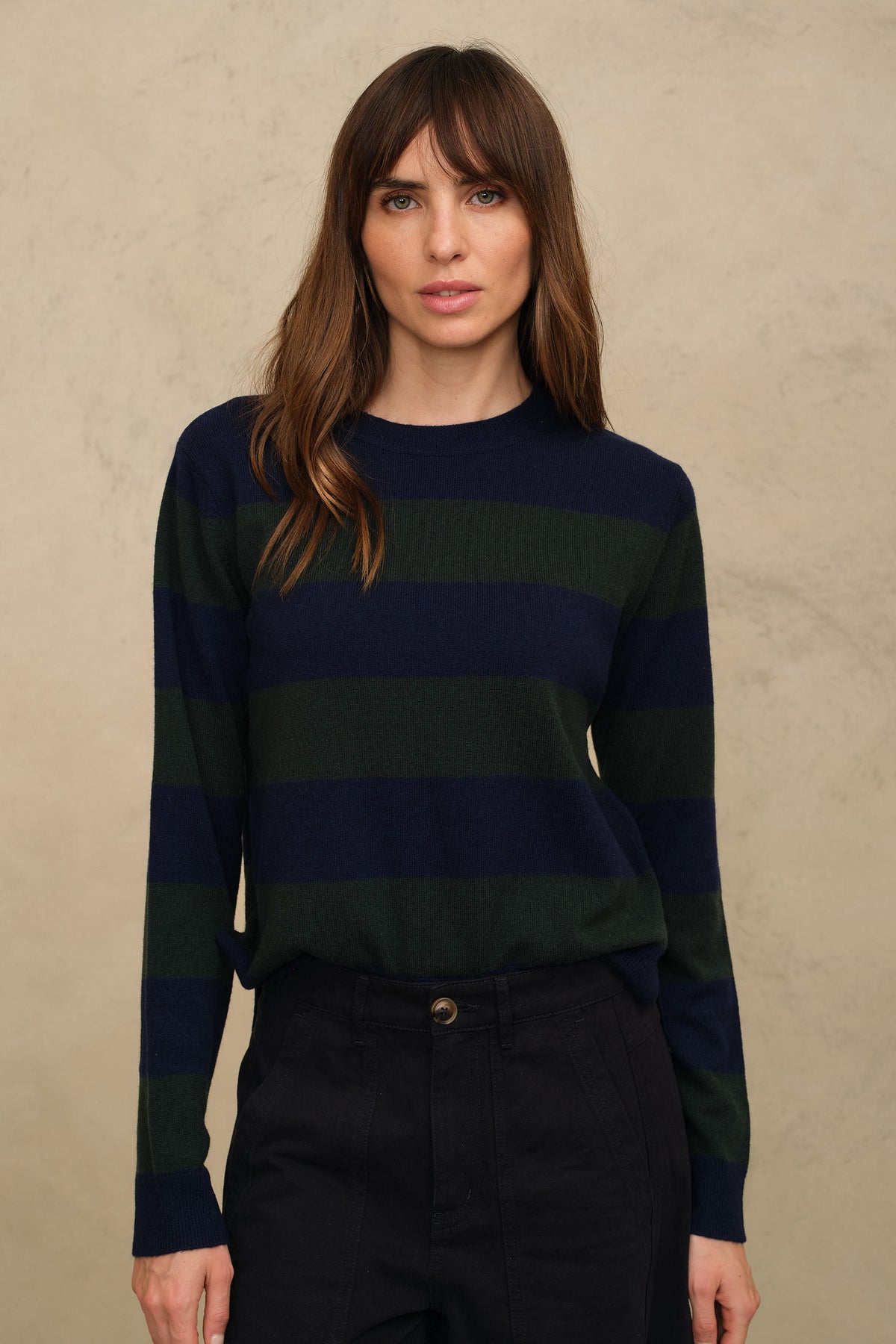 Front of the navy and green striped wool and cashmere jumper, tucked at the waist