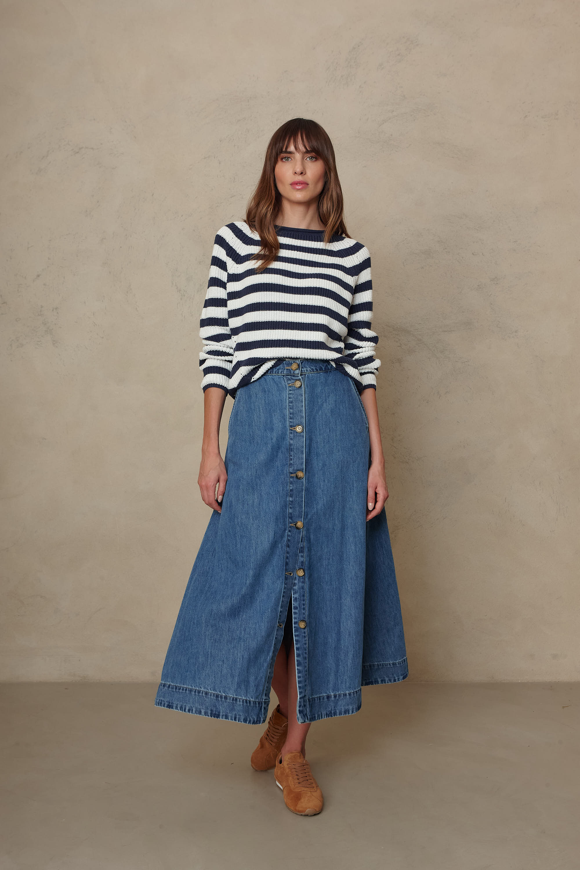 Polly navy striped pointelle jumper worn with a denim midi skirt and tan boots