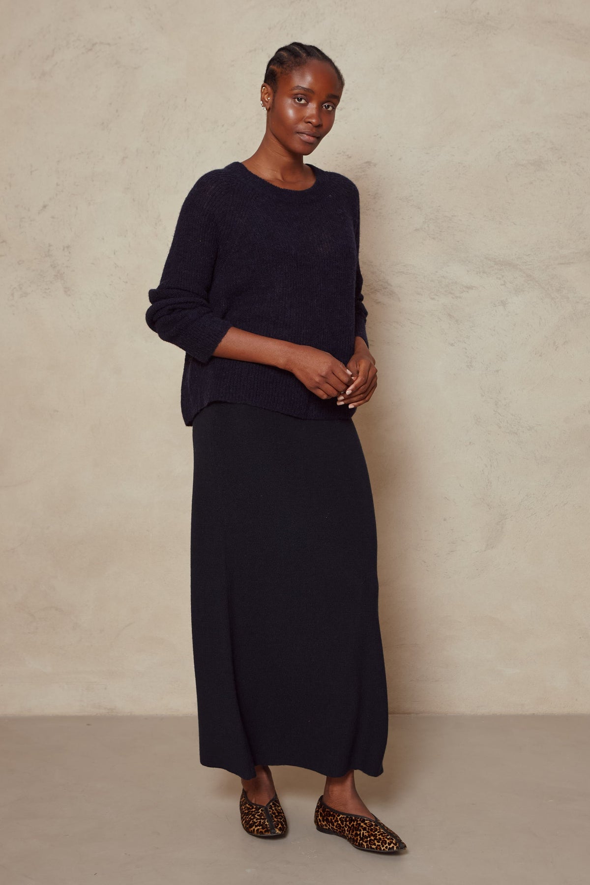 Model in the Felicity navy loose knit jumper with a navy maxi skirt, full length