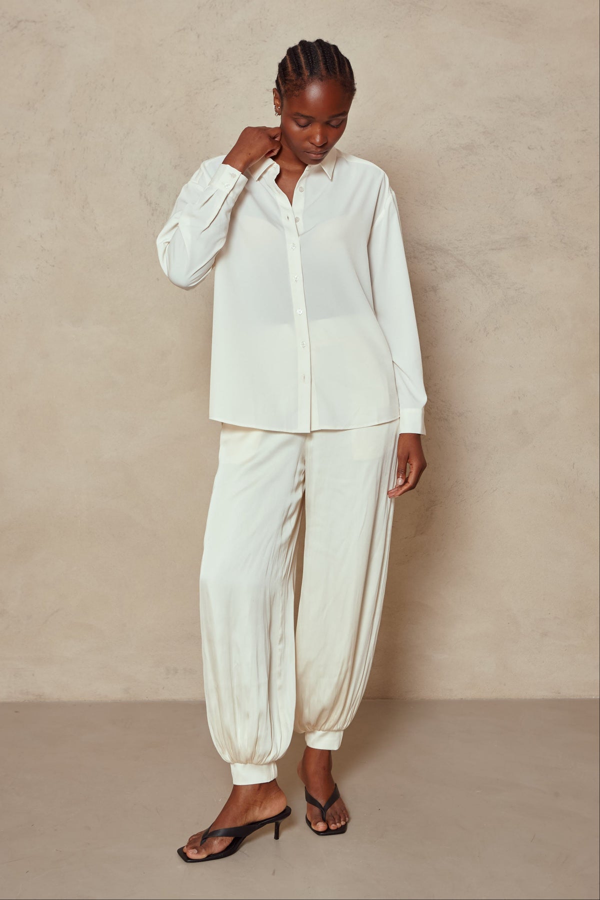 Model in the Maeve balloon trousers in ivory with an ivory shirt and heeled sandals, full length