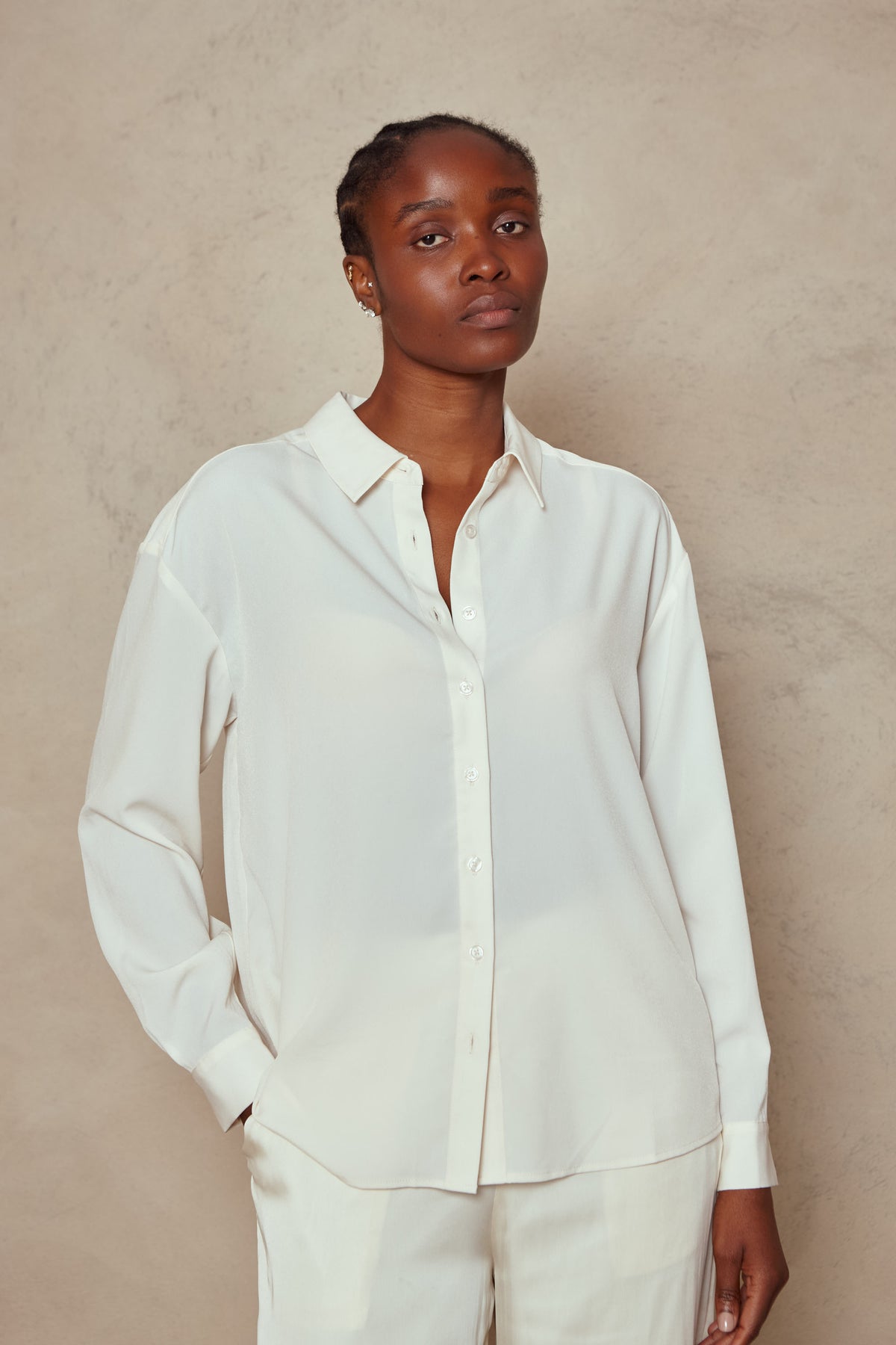 Close up of the Margot shirt in ivory worn open at the neck, front view