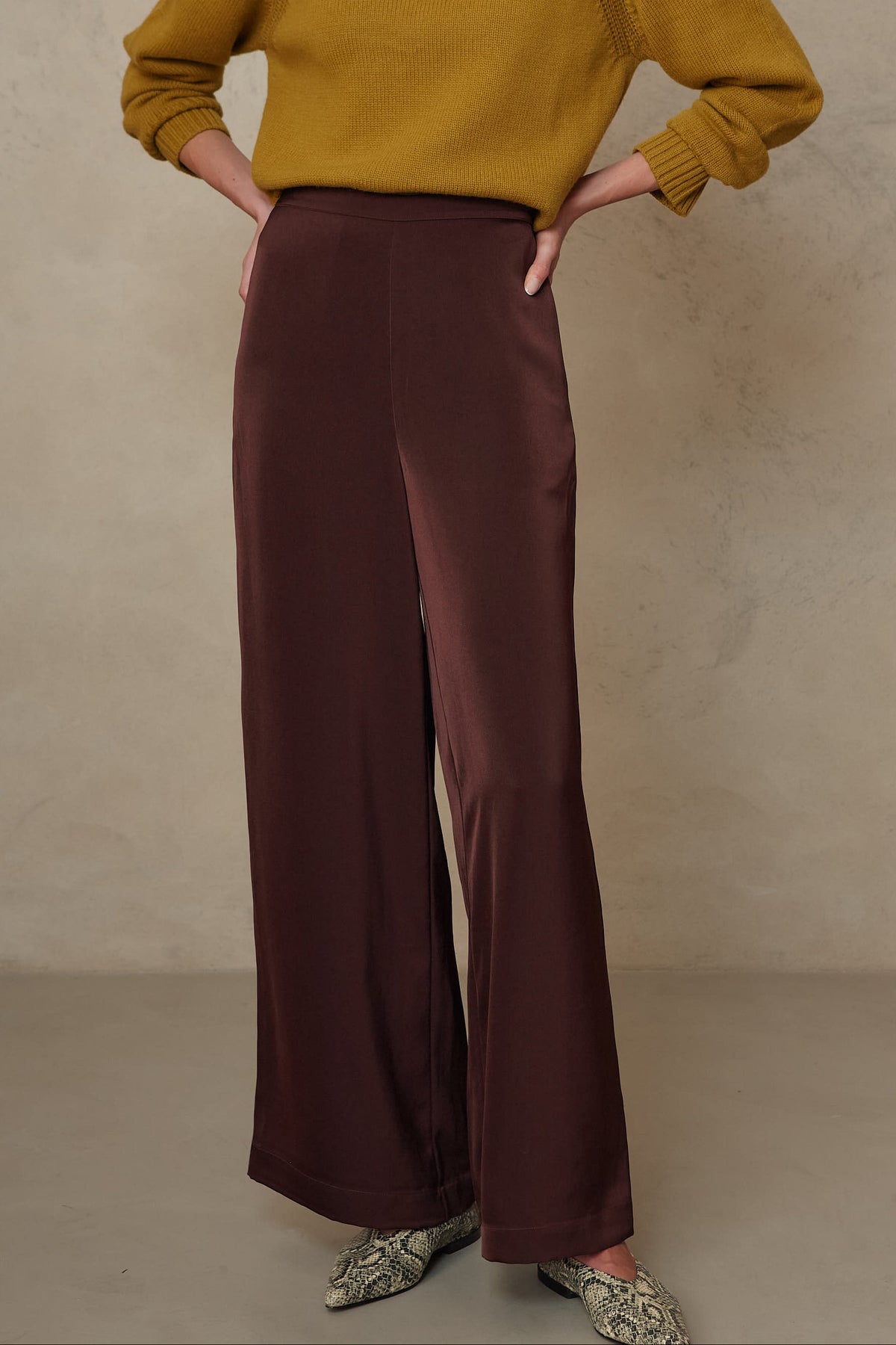 Hazel wide leg satin trousers in chocolate worn with the Blythe funnel neck cropped jumper in turmeric