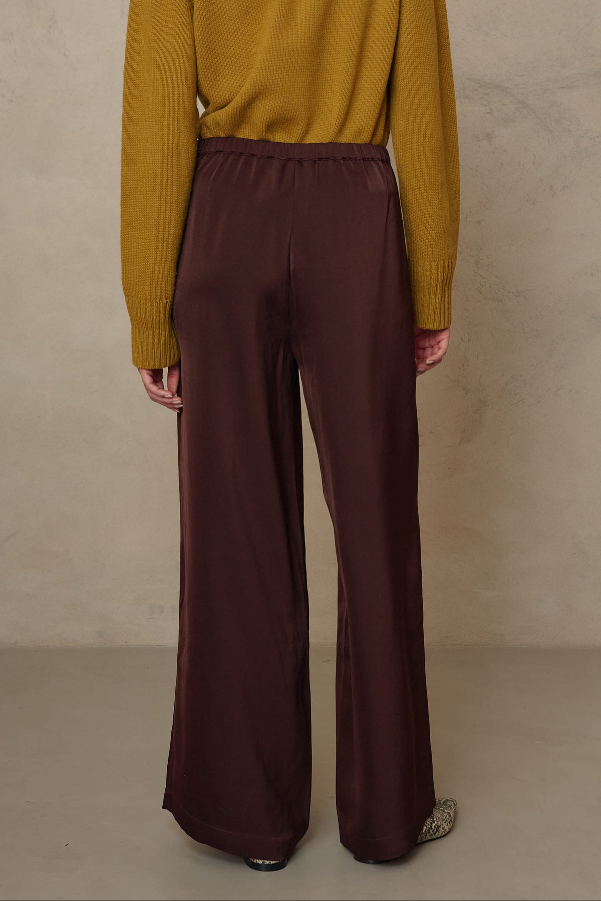 Hazel wide leg satin trousers in chocolate worn with the Blythe funnel neck cropped jumper in turmeric