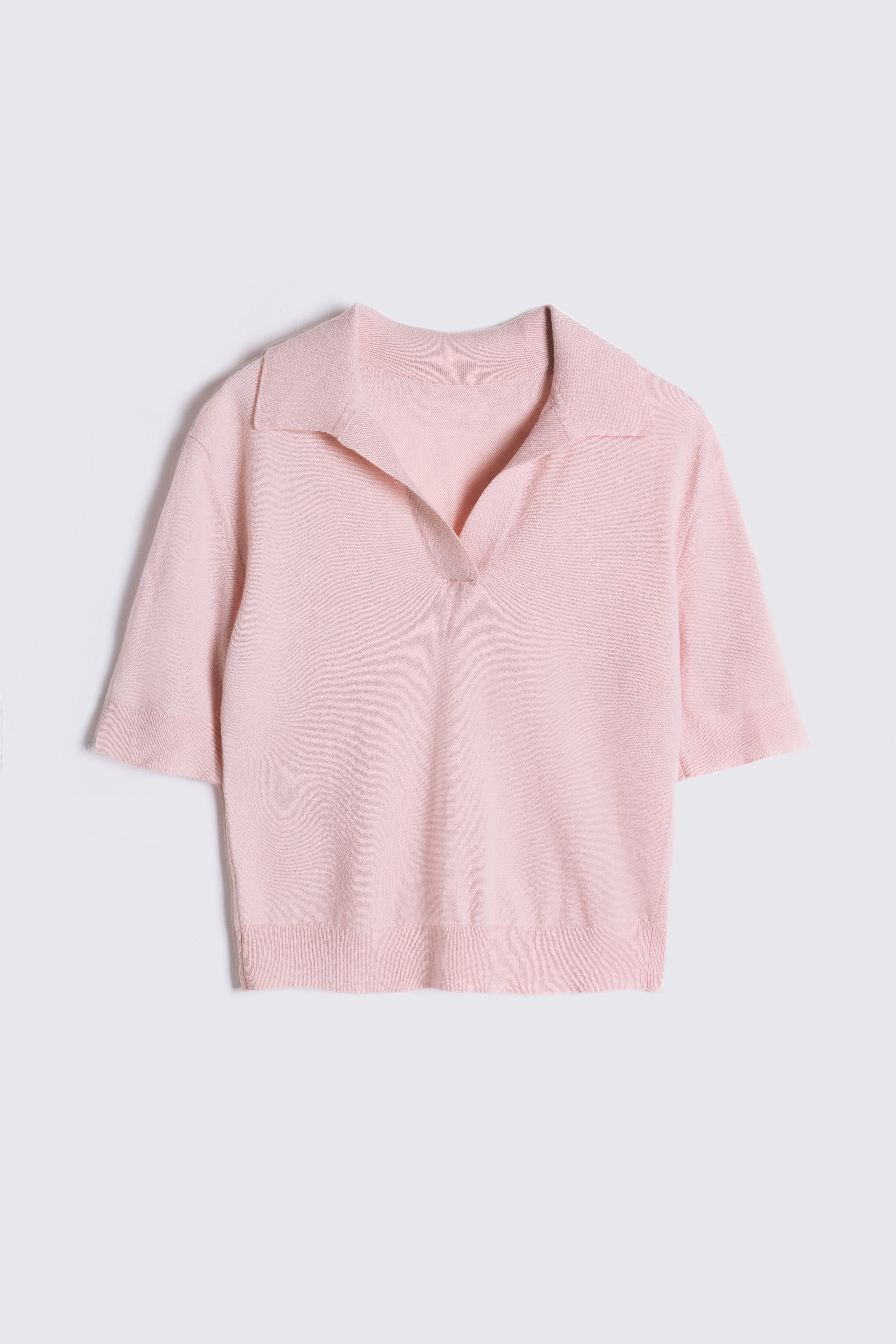Pink jumper on a light gray background