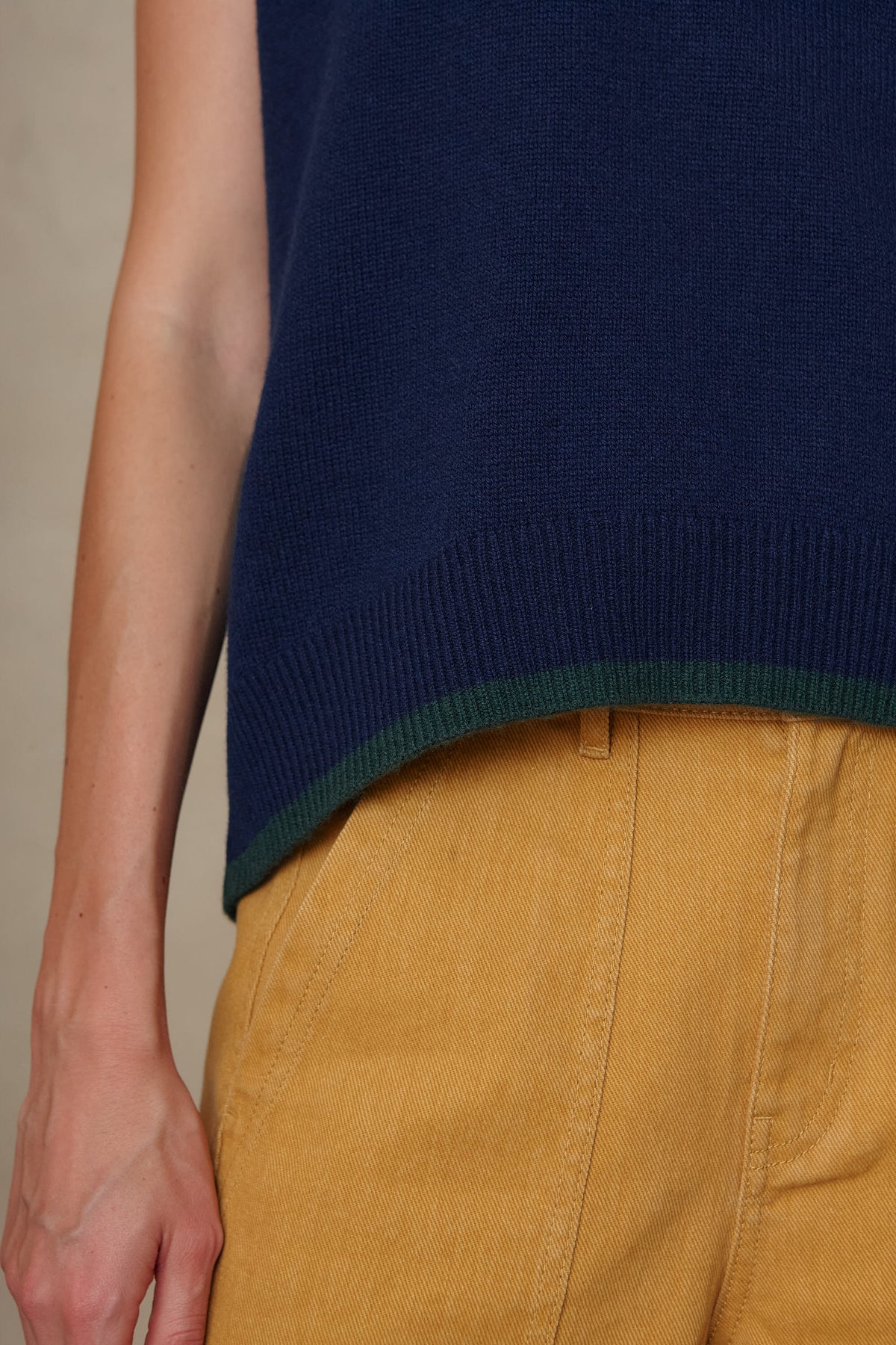 Detail of the Ora tank in navy showing the green tipped ribbed hem
