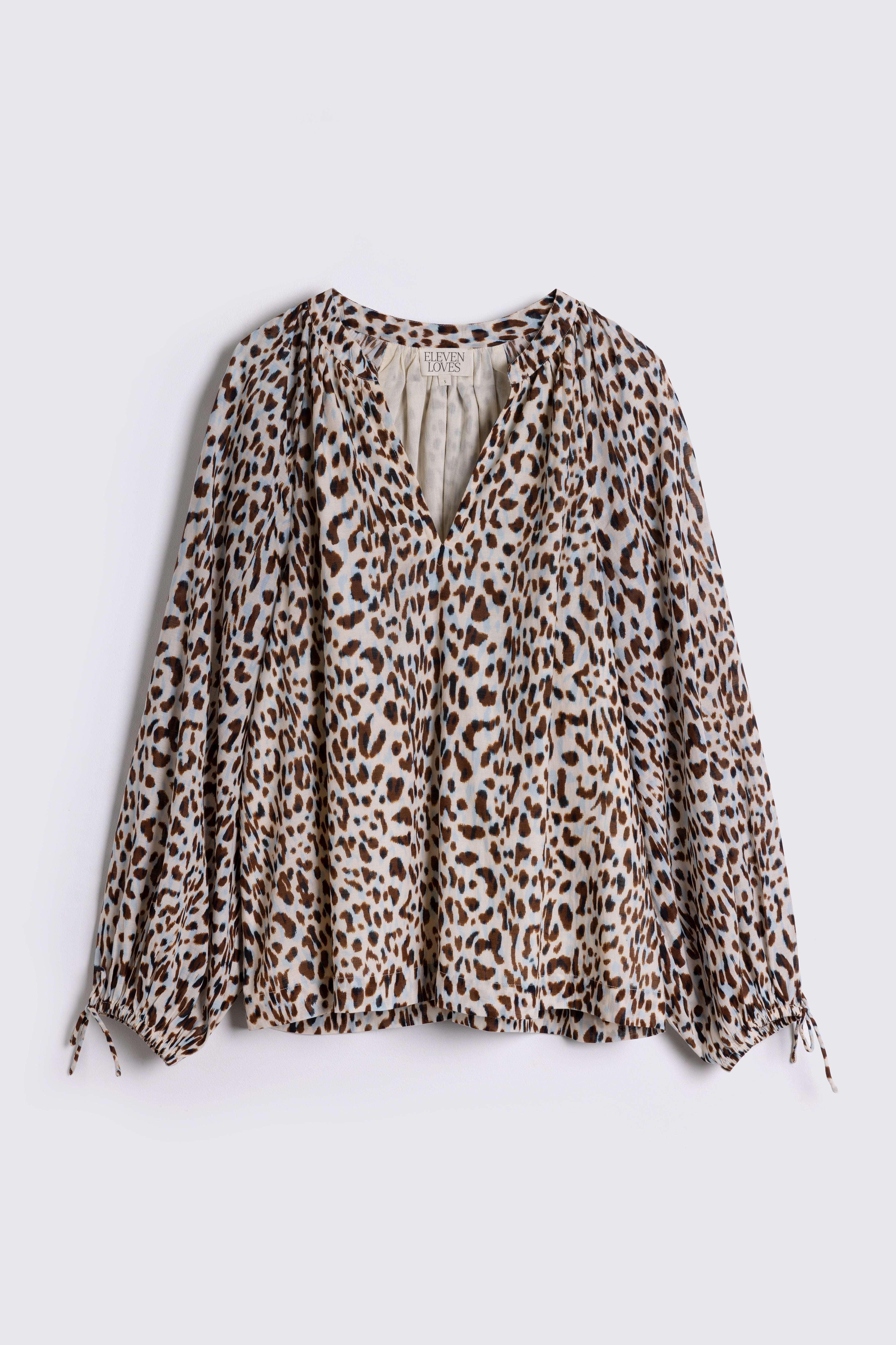 Leopard print blouse on a white background