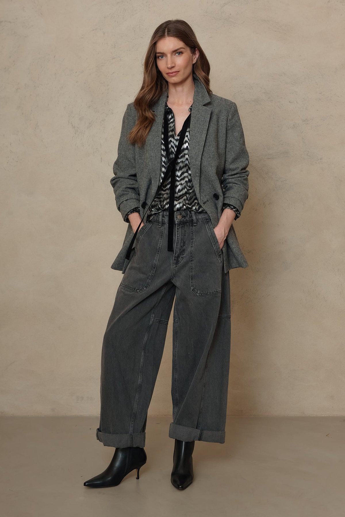 Teyha houndstooth blazer worn with hands in pockets over tailored trousers
