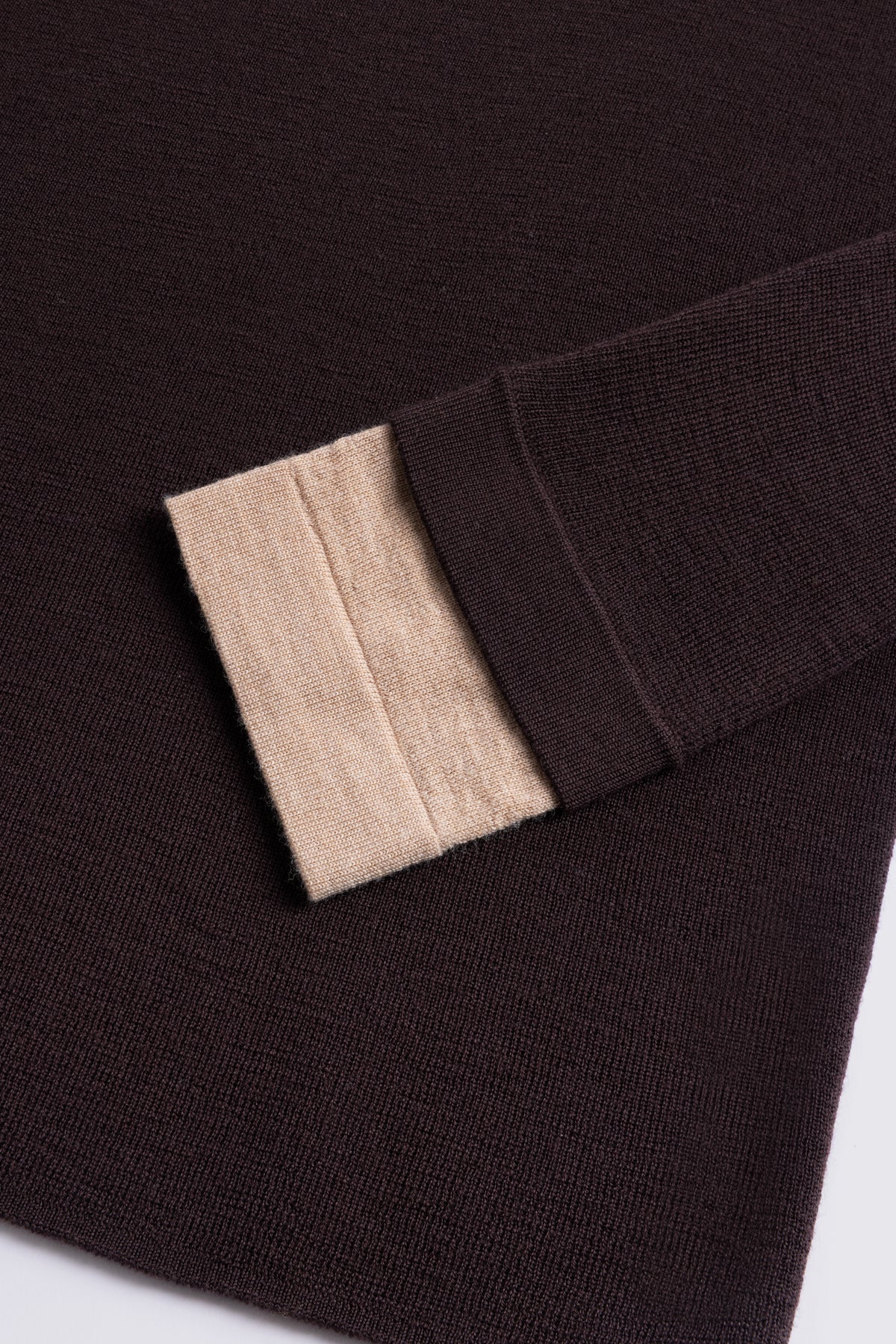 Chocolate merino crew neck jumper with a camel cuff, shown flat