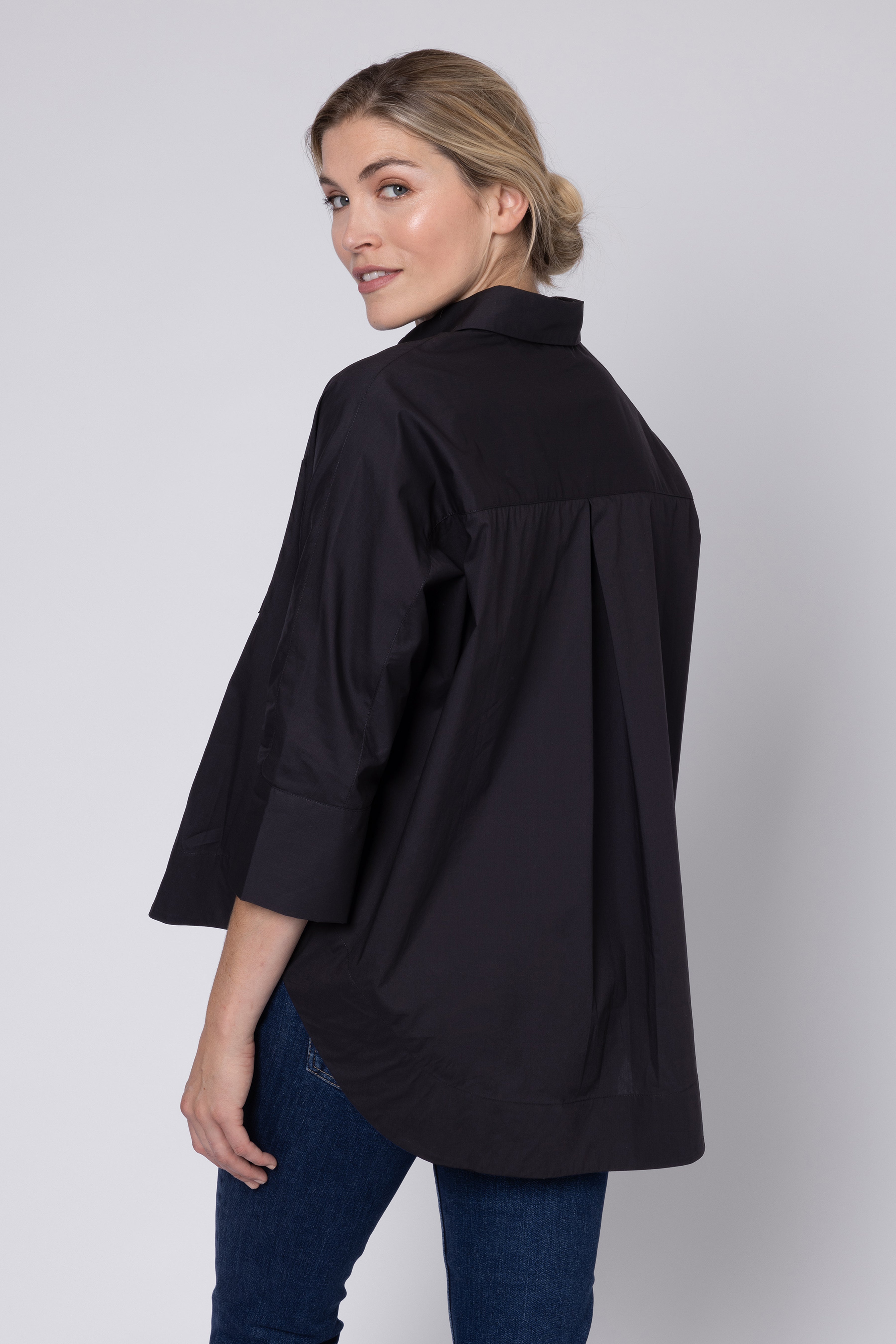 model wearing black shirt and jeans