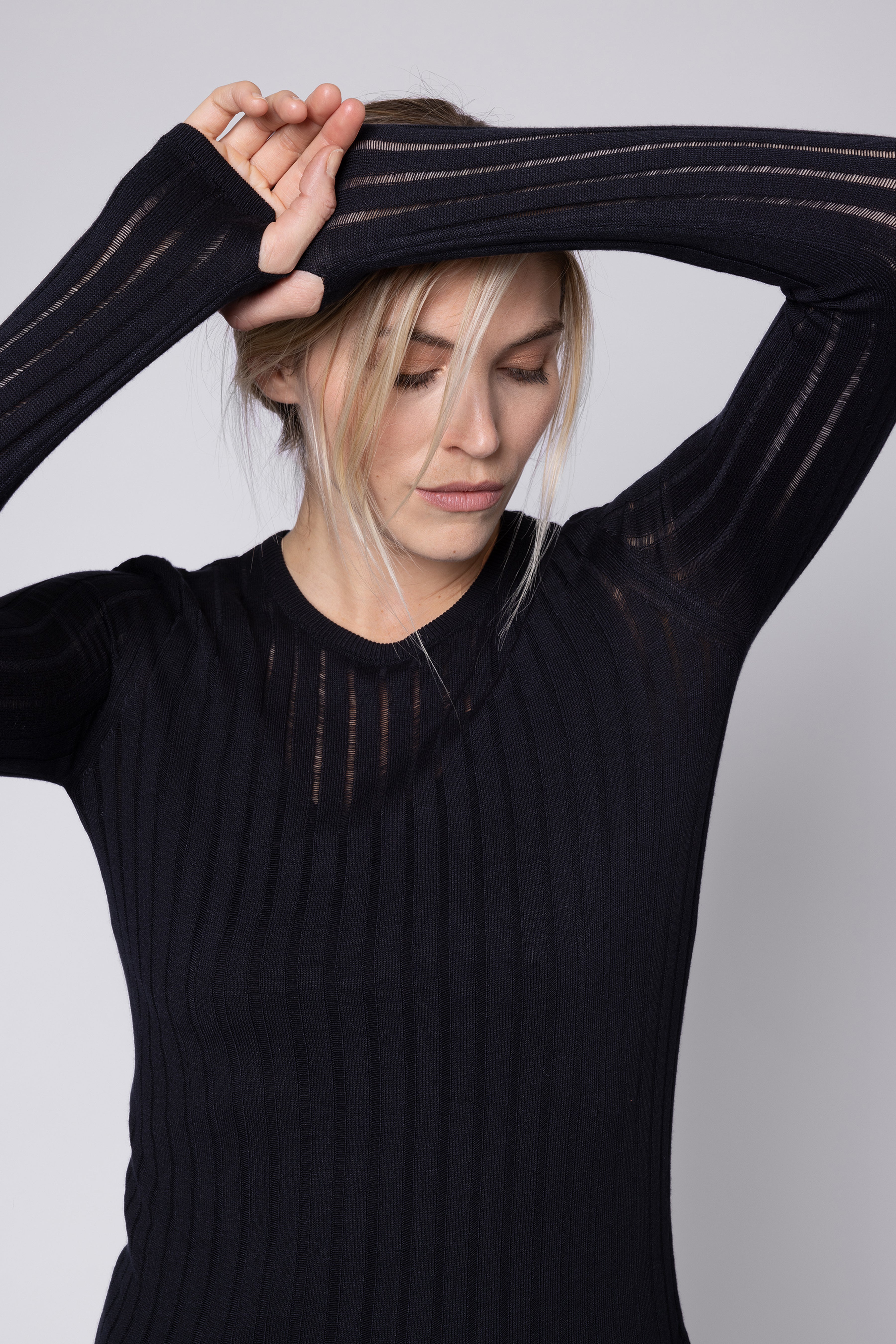 Black sheer top styled with a black bra, the Iggy Sheer Rib Jumper in black by Eleven Loves
