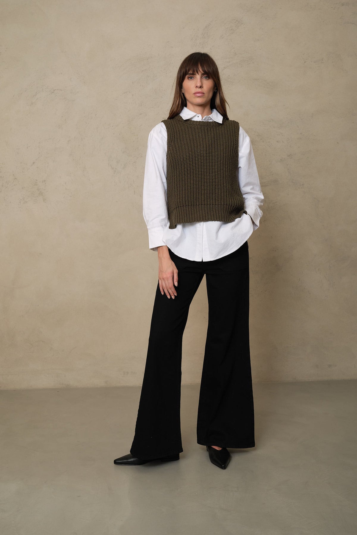 How to style a knitted vest: the Rebecca ribbed tank in olive over The Perfect Shirt in white with black wide leg jeans