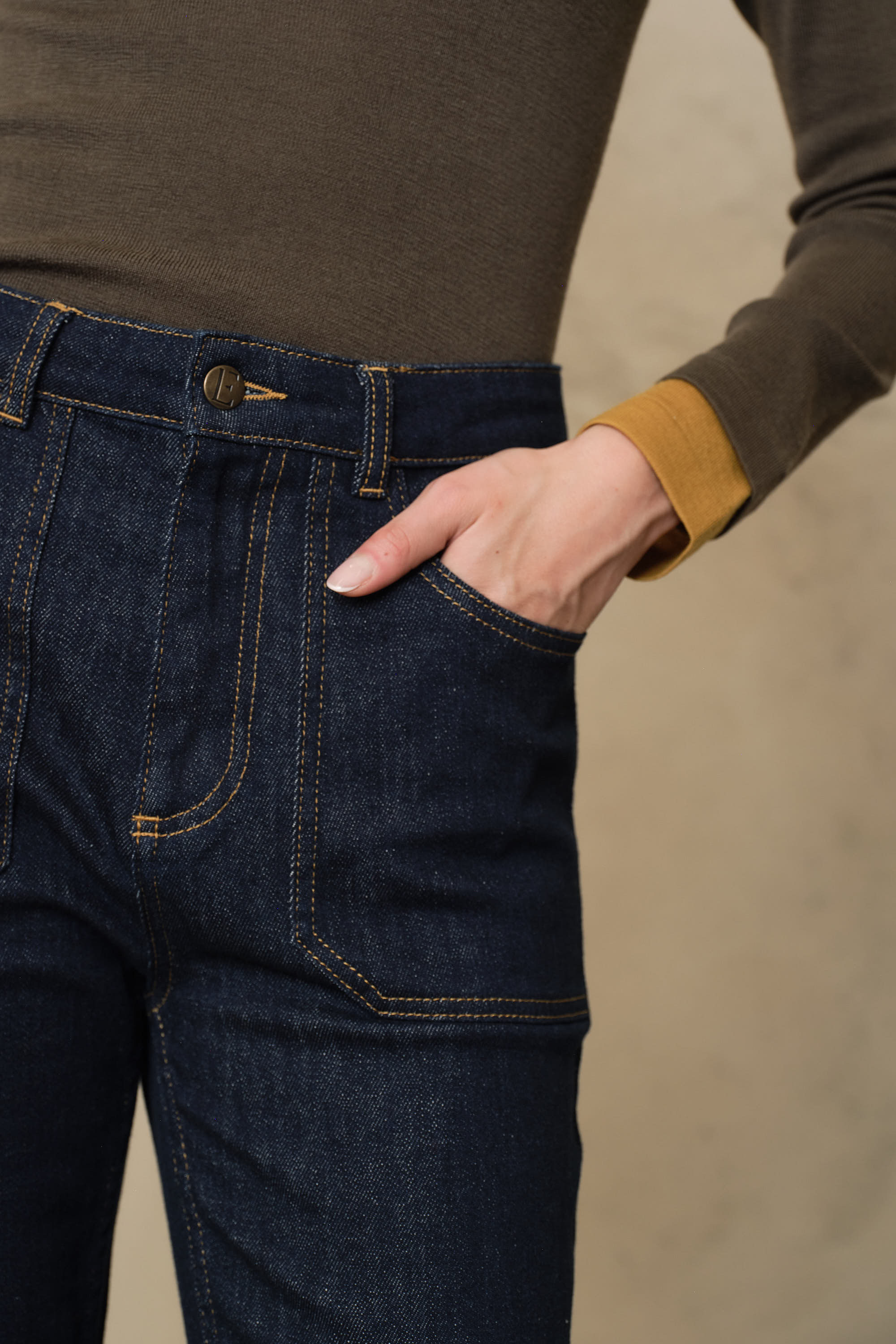 Close detail of the Frankie rinse wash jeans, showing the contrast stitch carpenter pocket and button fly