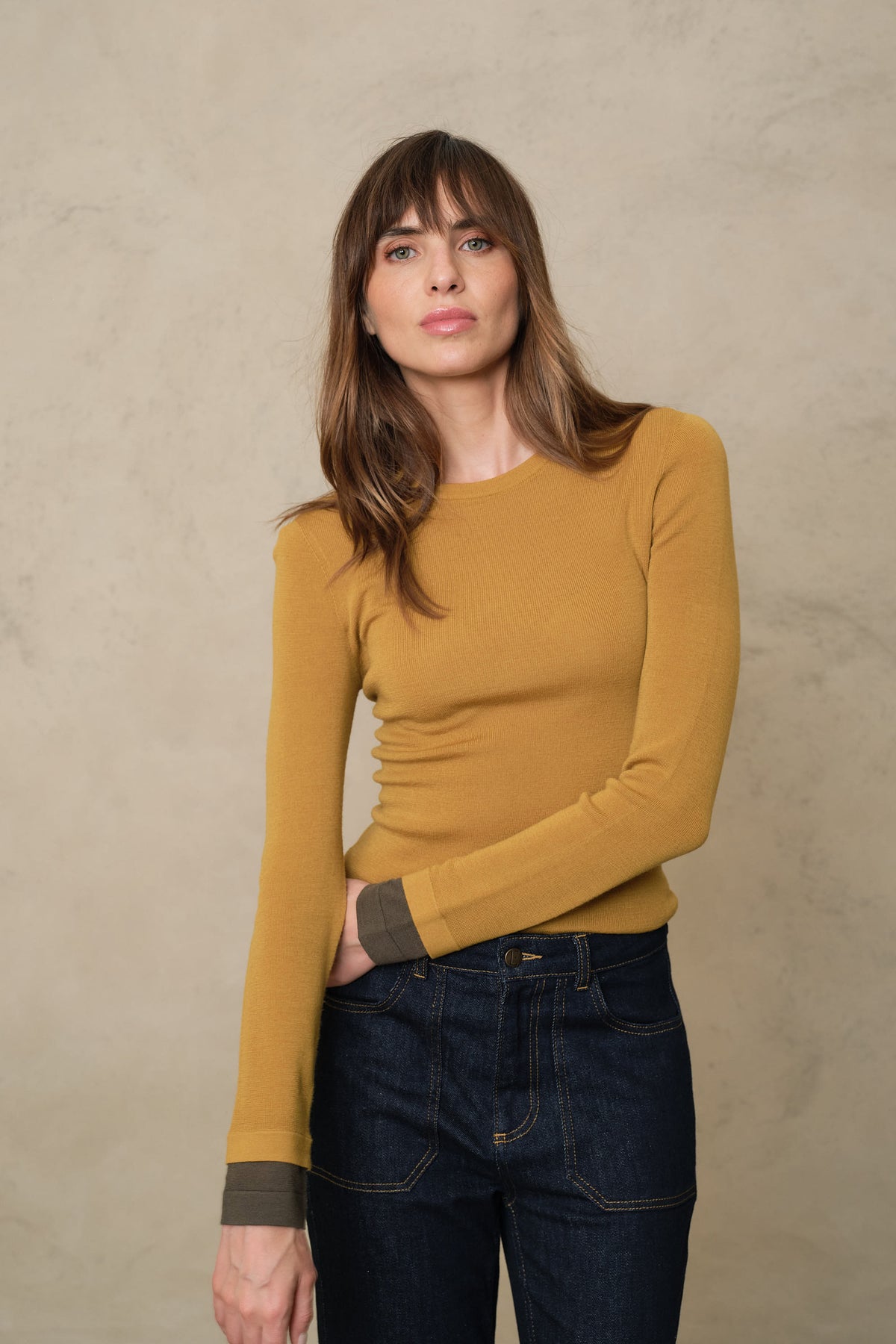Trinny fine merino crewneck in mustard with a dark olive sleeve