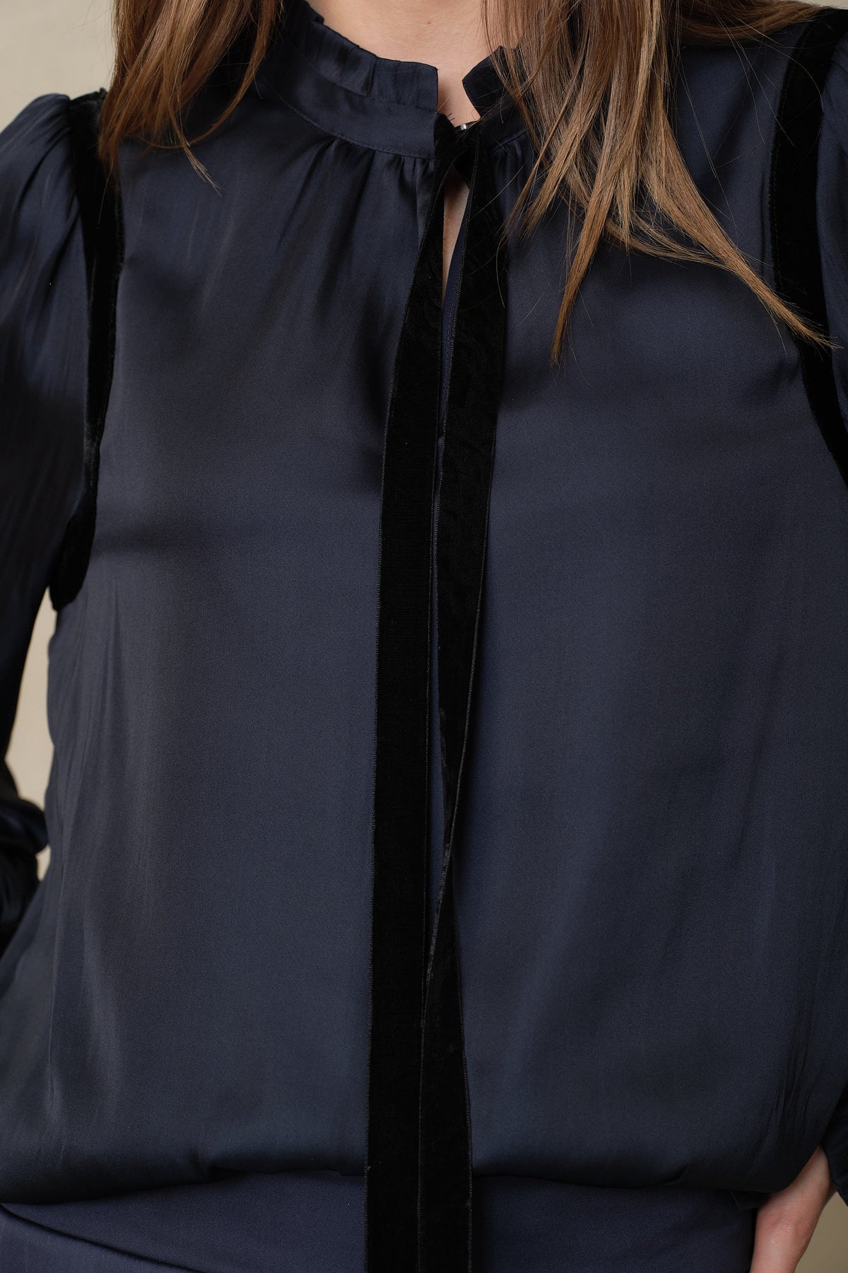 Detail of the Jules navy blouse showing the velvet tie and gathered neckline