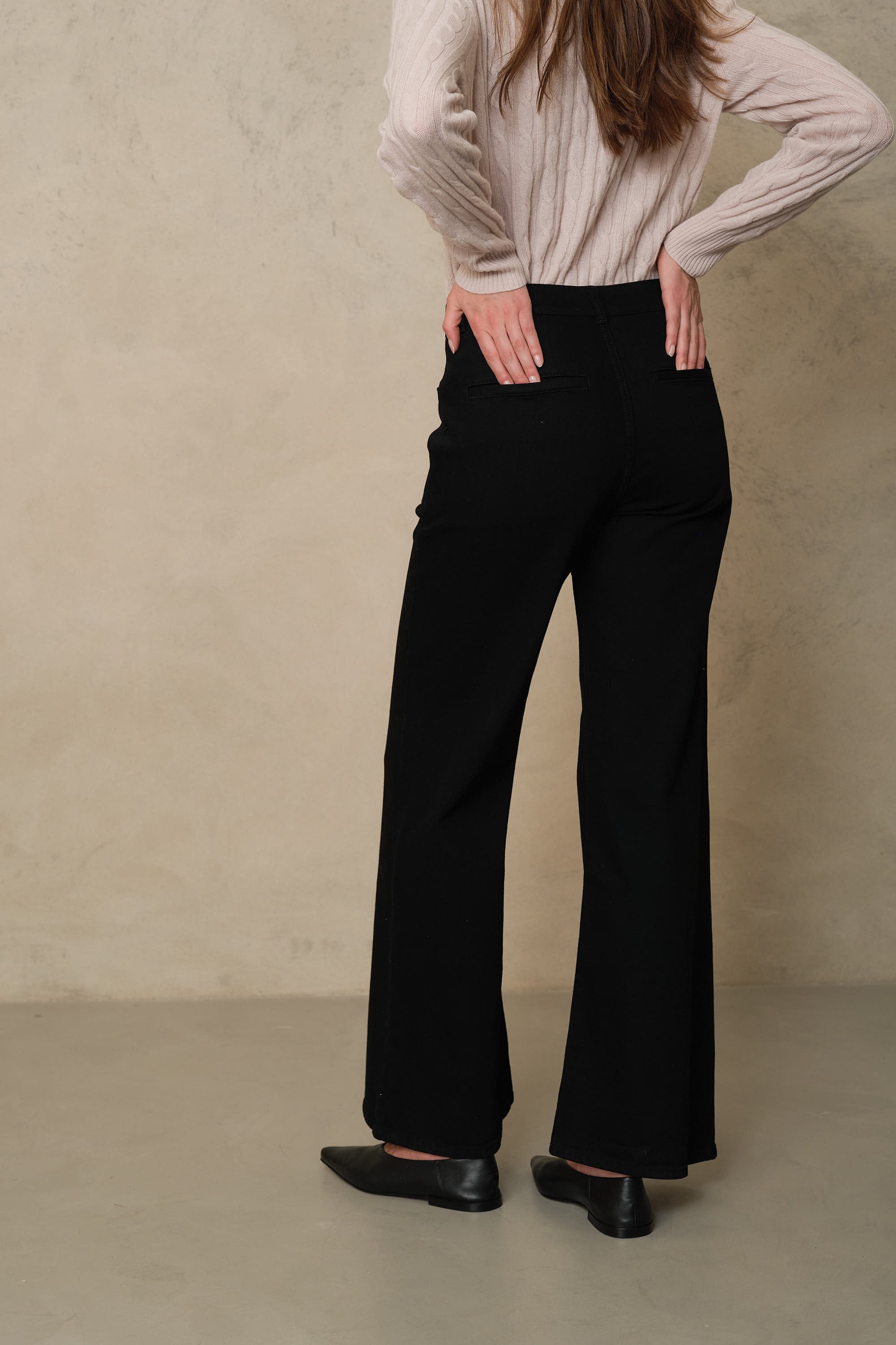 Back of the Frankie black wide leg jeans, showing the welt back pockets and full length leg