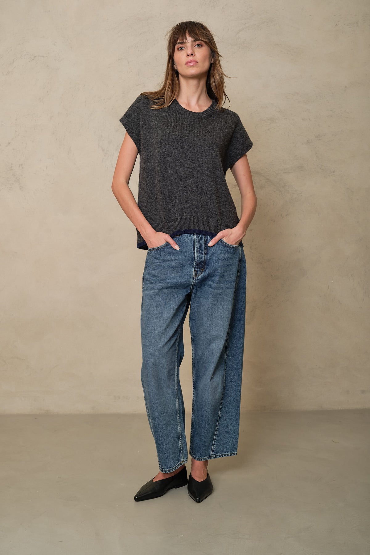Rosie mid wash twist front jeans styled with a charcoal knitted T Shirt, front view