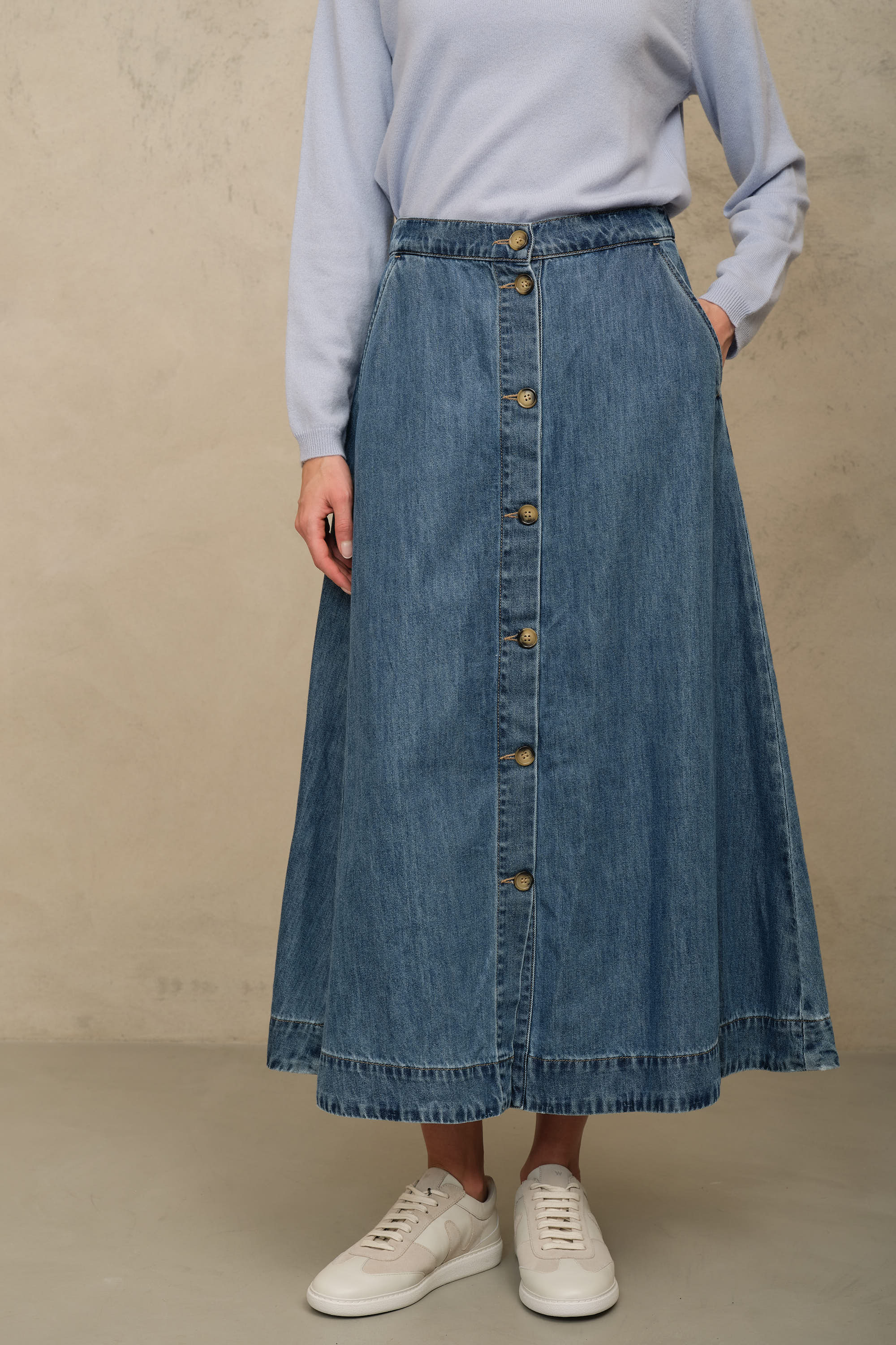 Imogen mid wash denim skirt with a button front and A line shape, worn with a pale blue jumper