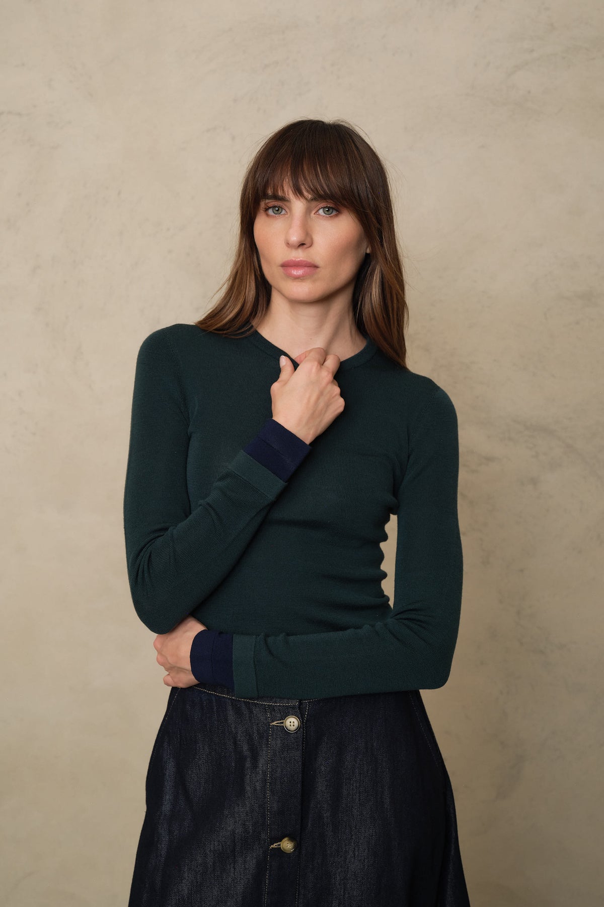 Trinny fine merino crewneck in bottle green with a navy sleeve