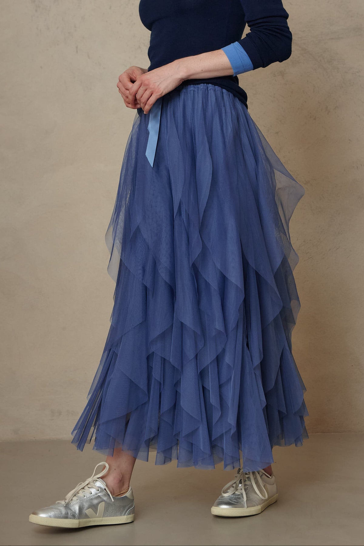 Close up of the Iris lapis blue tulle skirt with a navy jumper, side view
