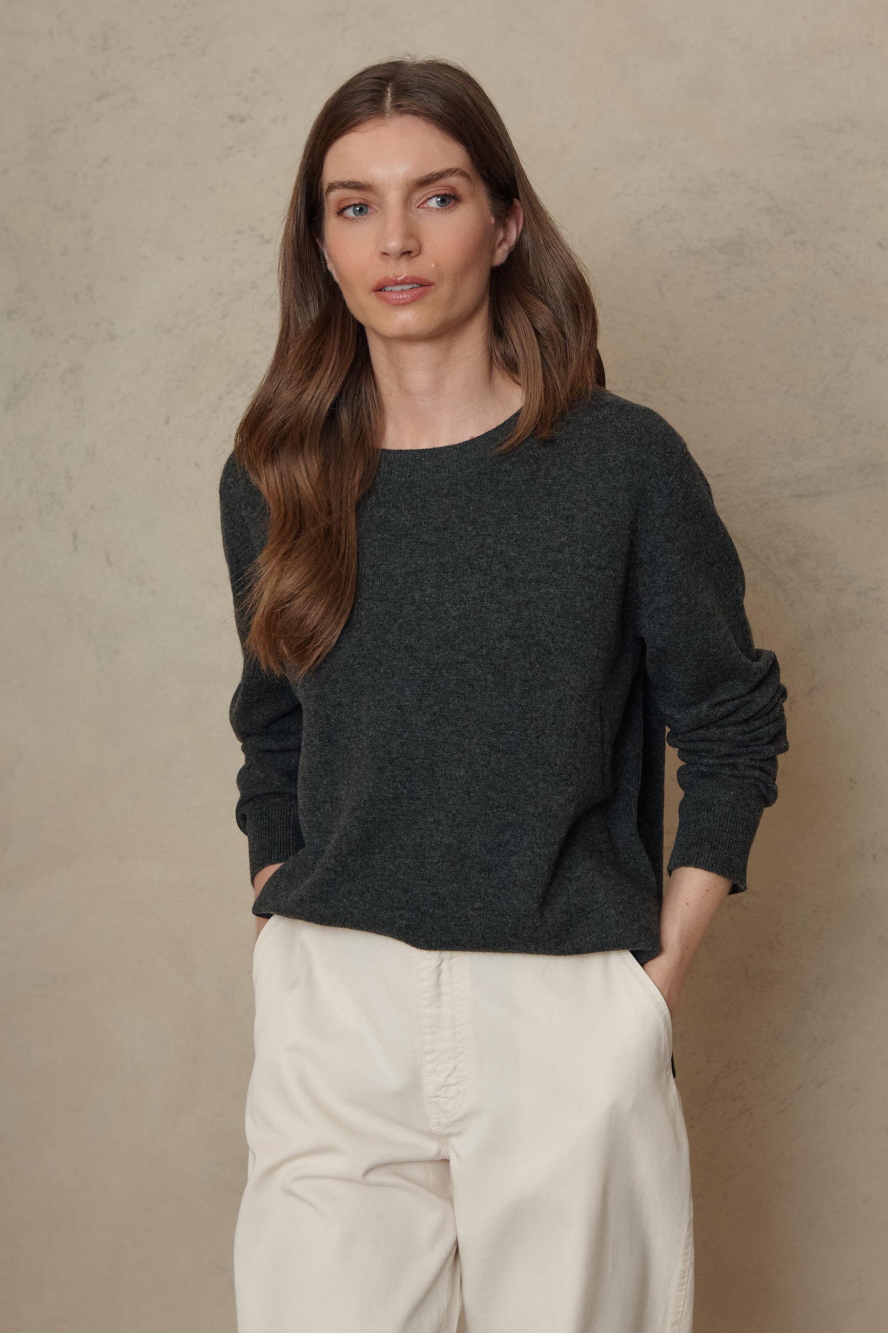 Alex charcoal cashmere blend jumper worn with ivory trousers, front view