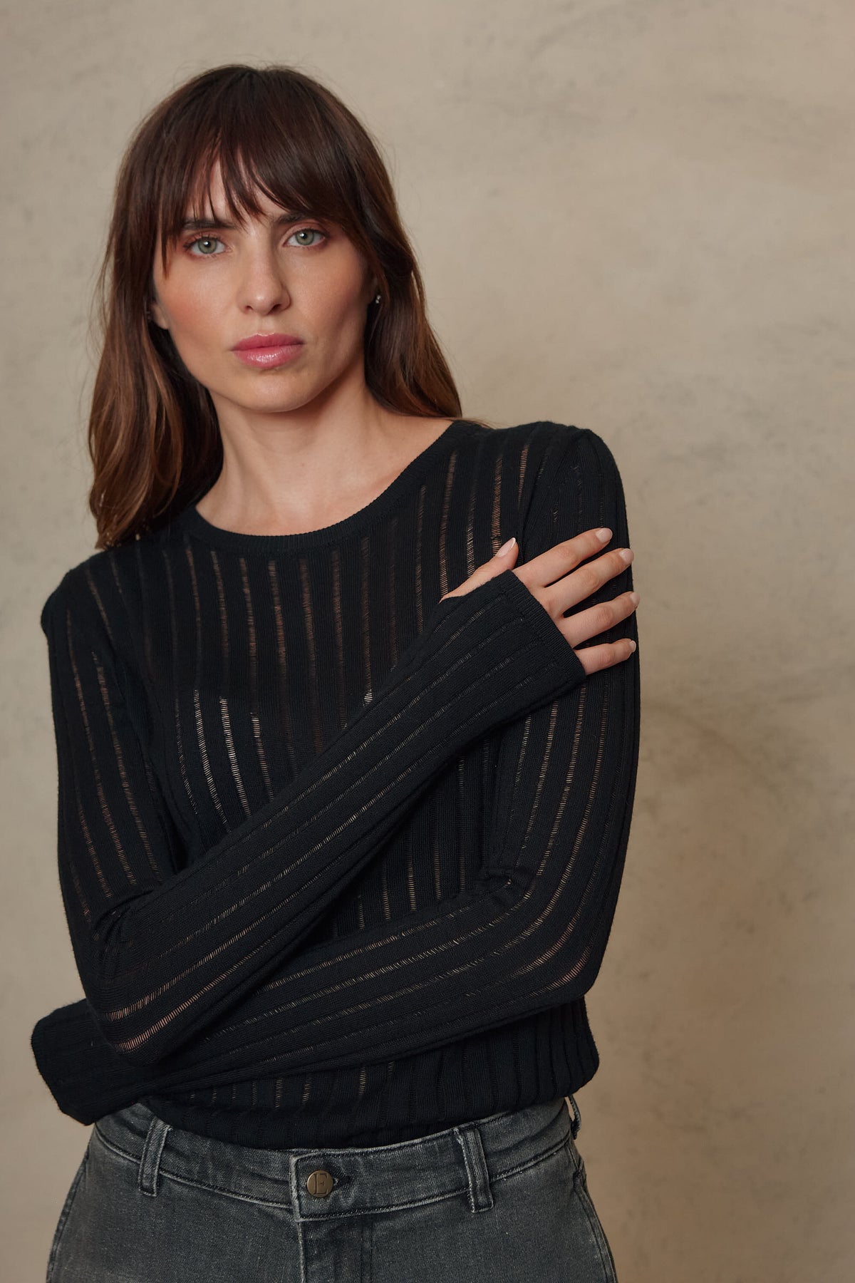 Iggy black sheer rib jumper worn with dark jeans, half body view