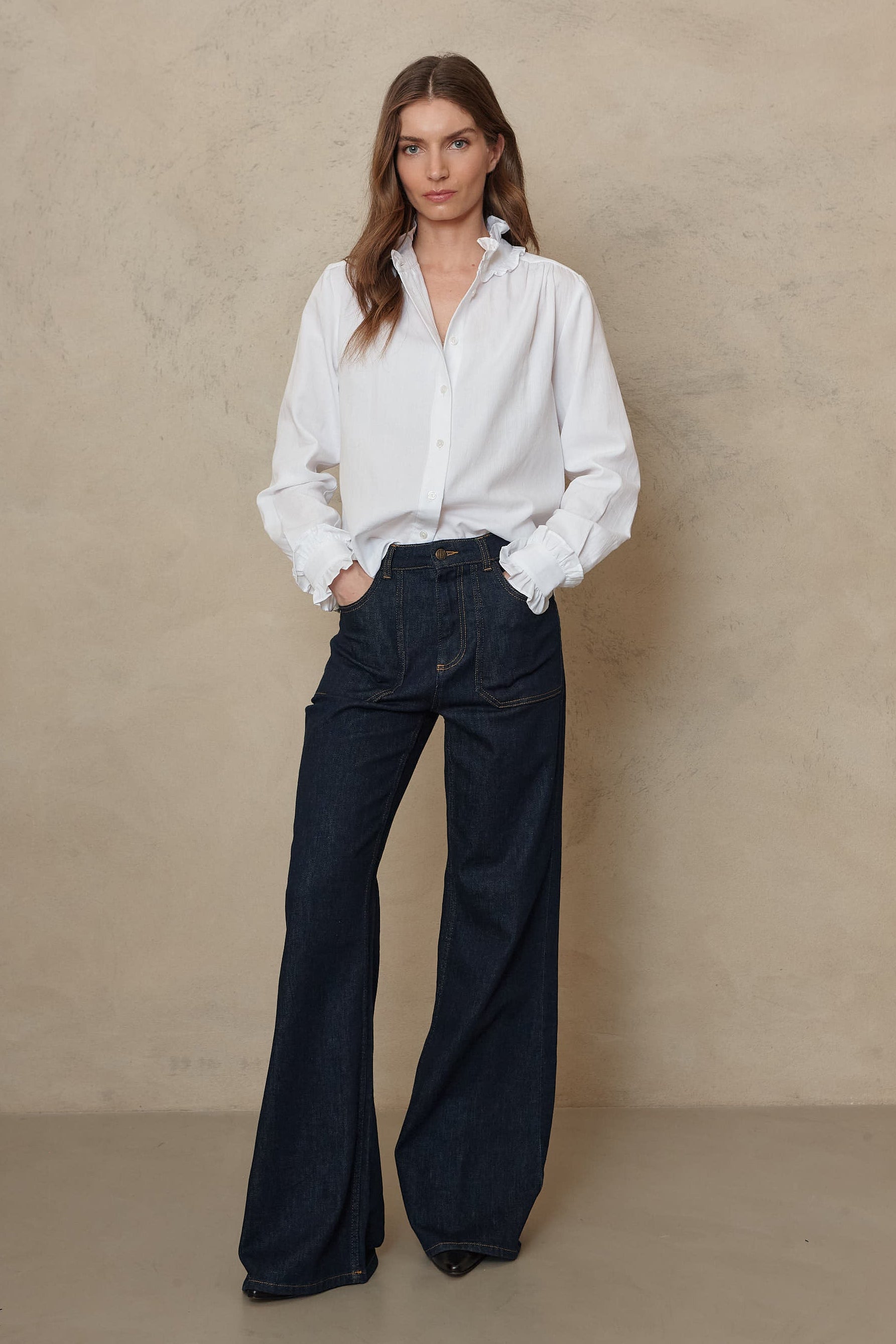 Ivory ruffle collar shirt worn loose over the Frankie wide leg jeans in rinse wash