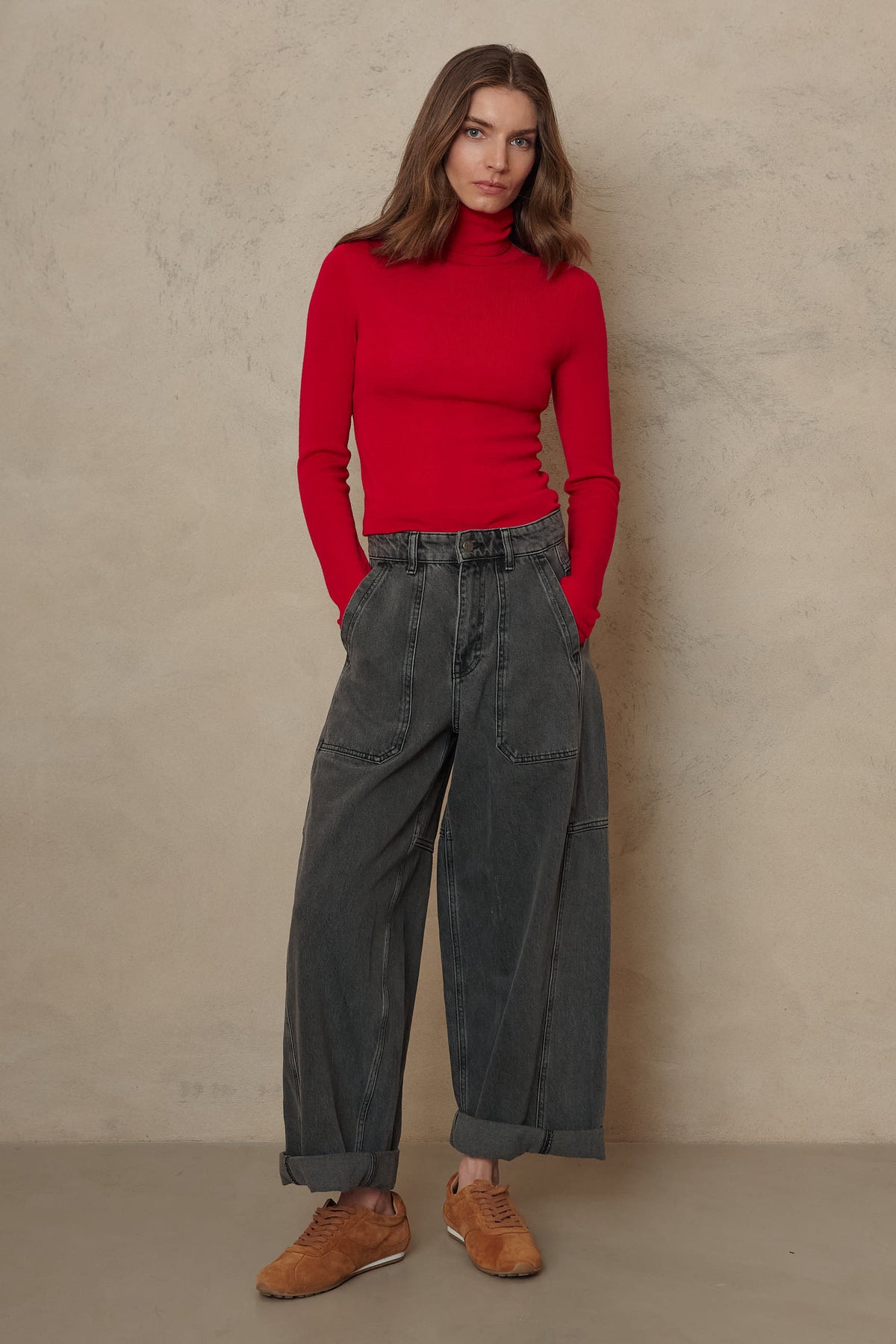 Gwyneth red roll neck with grey barrel leg jeans and tan shoes, full length