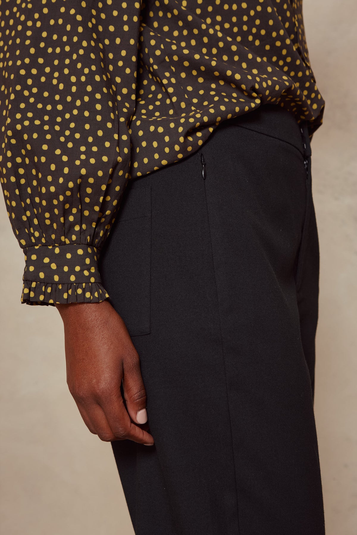Close up of the Tess clean cargo trousers in black, showing the front crease