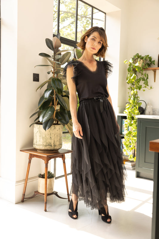 black tule maxi skirt worn by model in kitchen