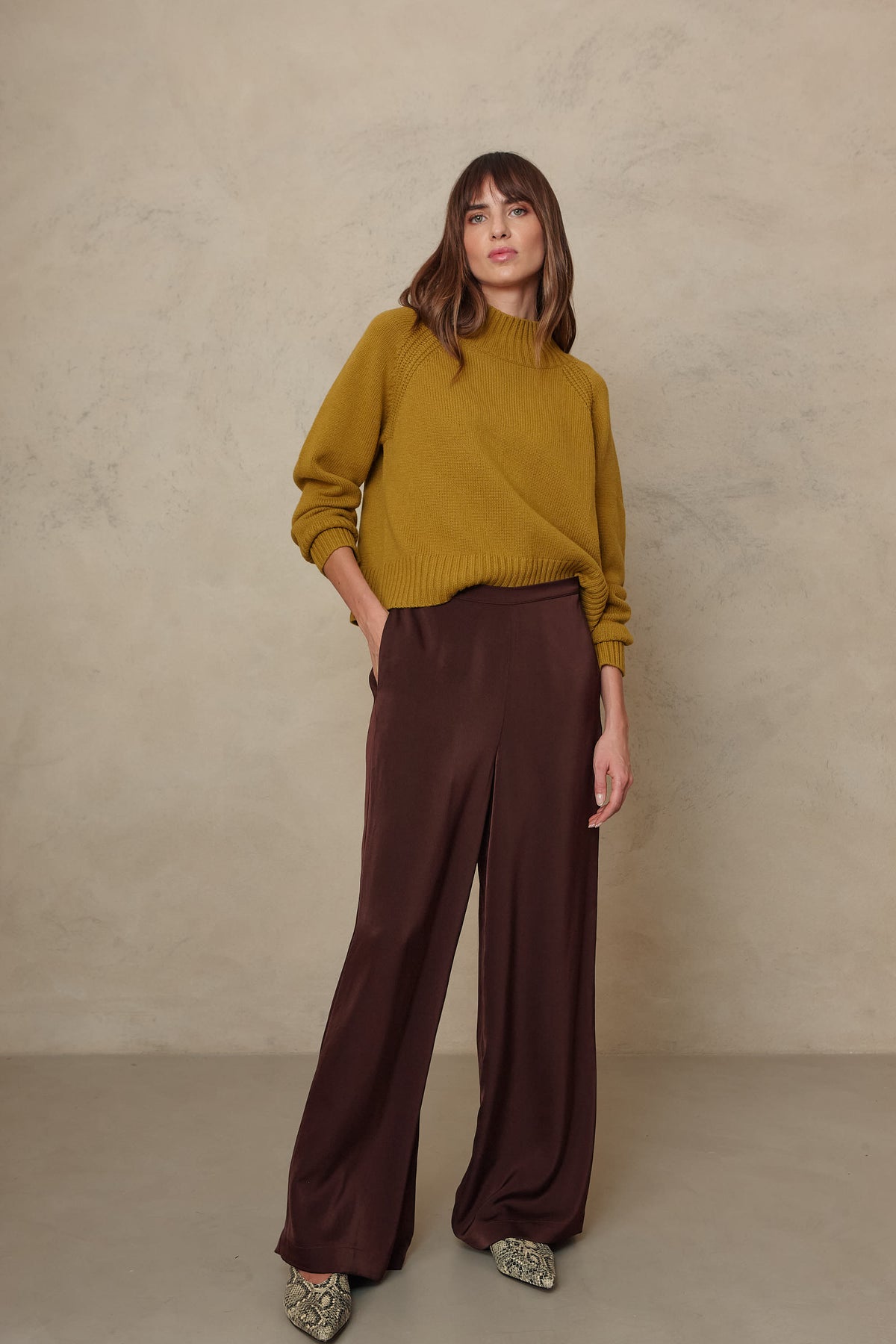 Hazel wide leg satin trousers in chocolate worn with the Blythe funnel neck cropped jumper in turmeric