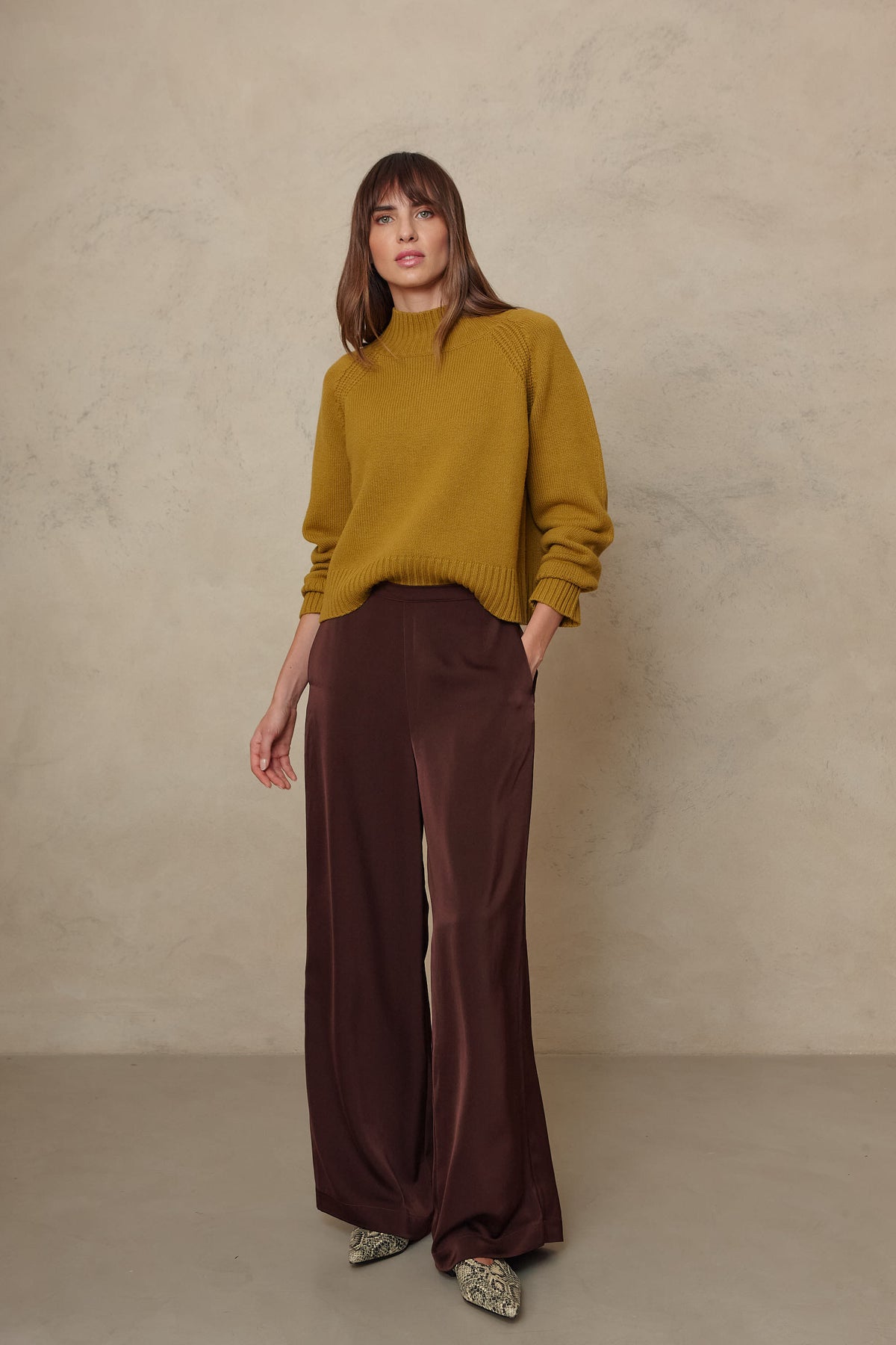 Hazel wide leg satin trousers in chocolate worn with the Blythe funnel neck cropped jumper in turmeric