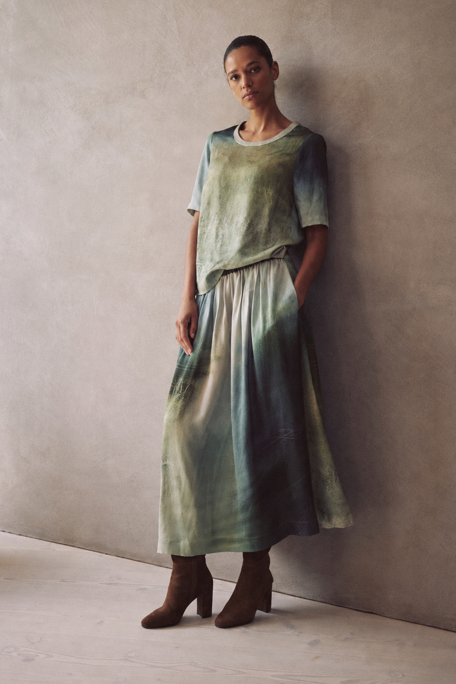 Saffy printed midaxi skirt in soft green tones, worn with the matching Faye art print satin T Shirt and brown suede ankle boots