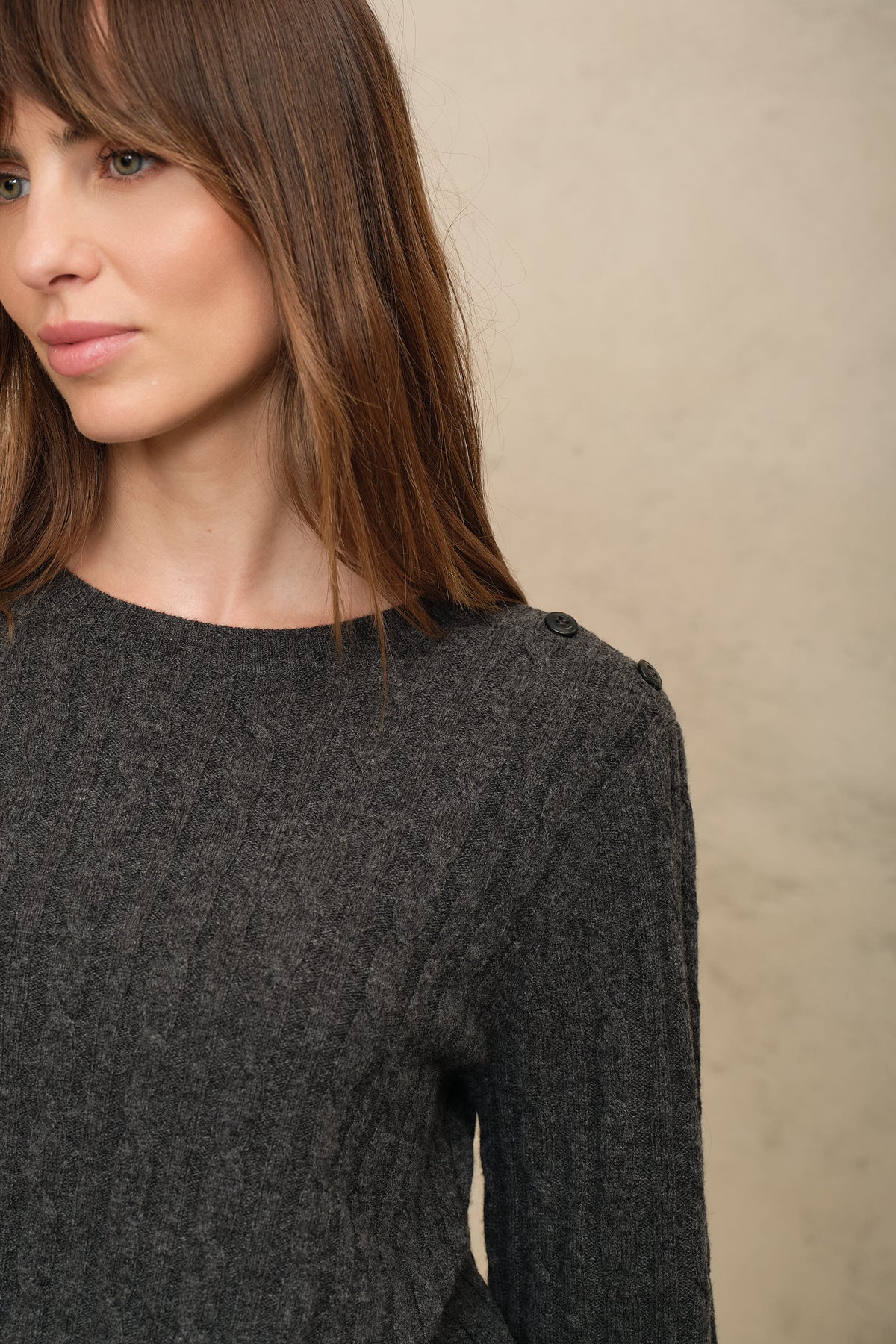 Close up of the cable knit and crew neck on the Cory jumper in charcoal