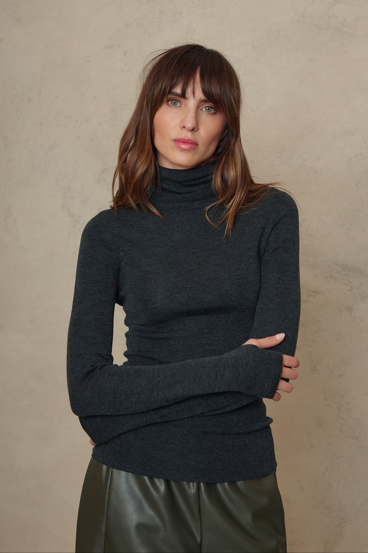 Gwyneth charcoal fine merino roll neck showing the neat fit and long sleeve