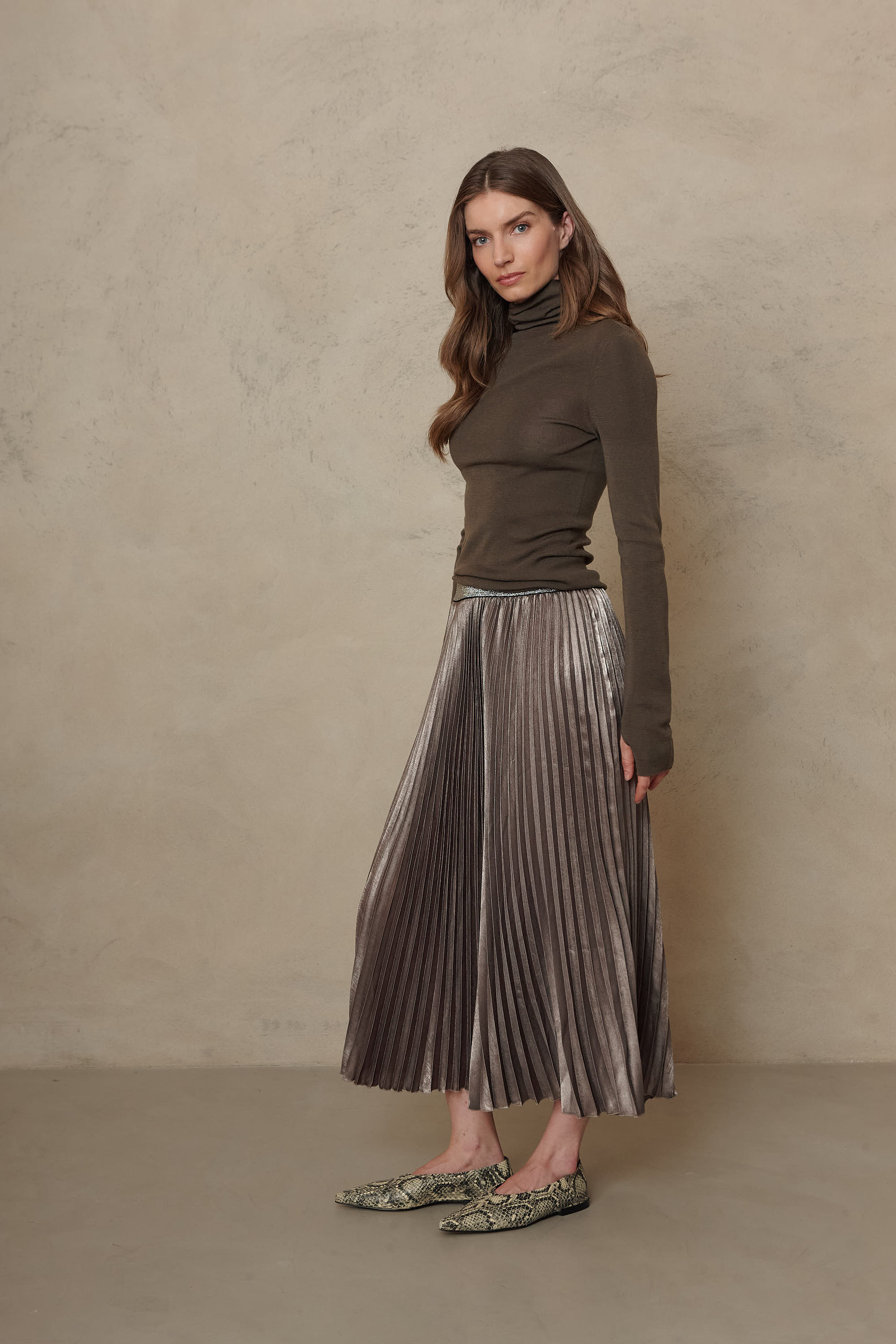 Mia pleated skirt in taupe worn with the Gwyneth fine merino roll neck in dark olive