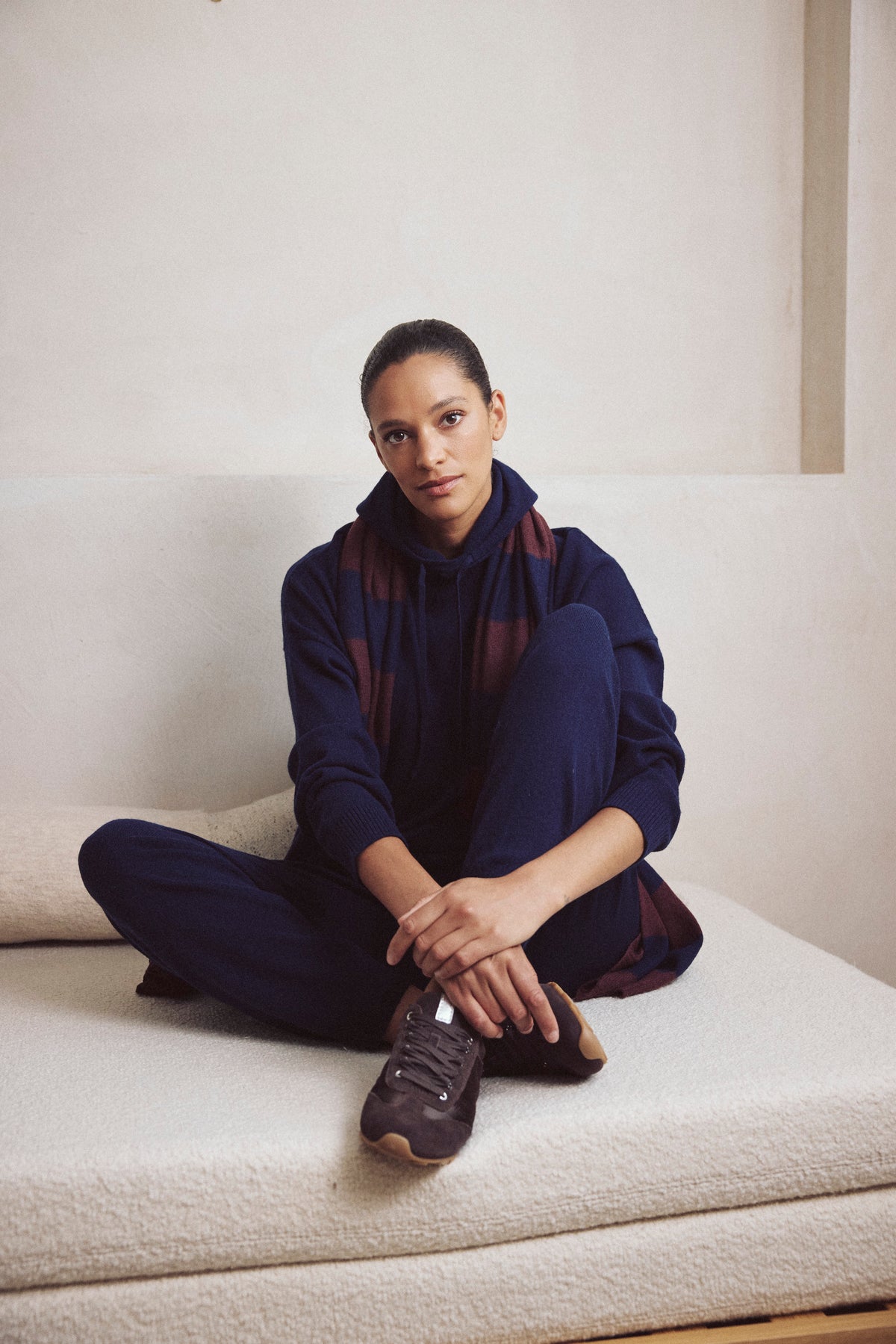 Antonia cashmere blend joggers in navy worn with the Heidi cashmere blend hoodie in navy and the Carmel cashmere blend scarf in navy and burgundy