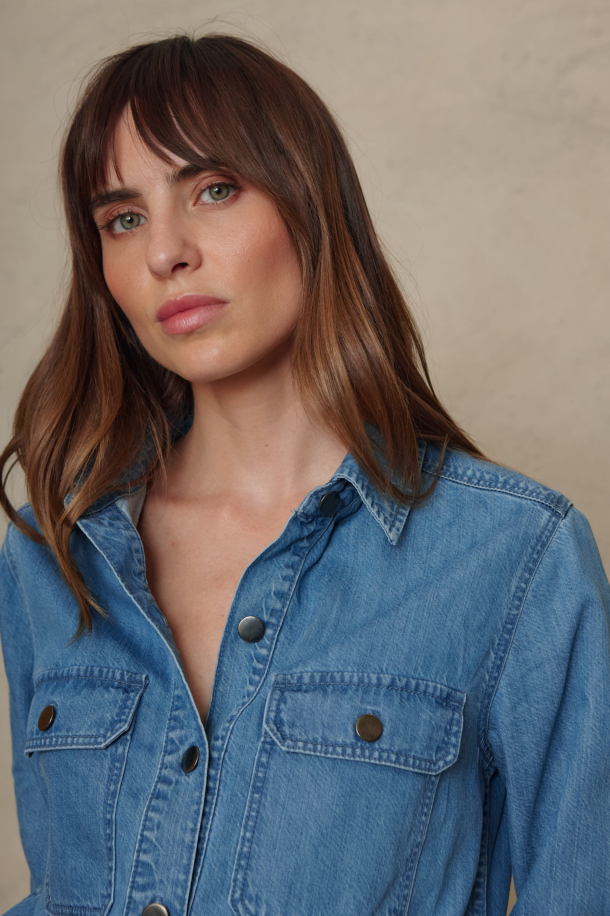 Joni mid wash denim shirt collar and contrast button detail, close up