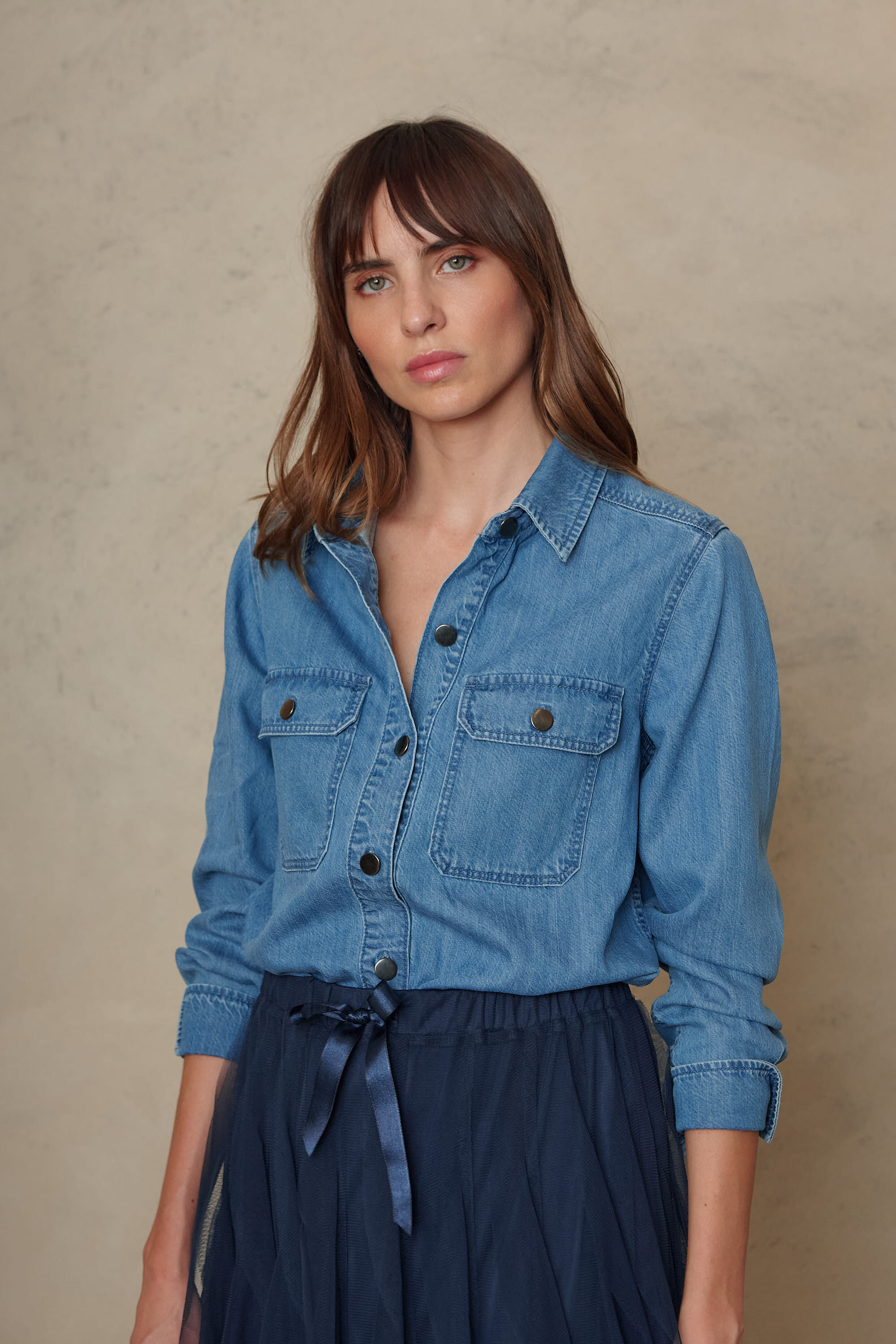 Joni mid wash denim shirt showing the chest pockets and contrast buttons, front view