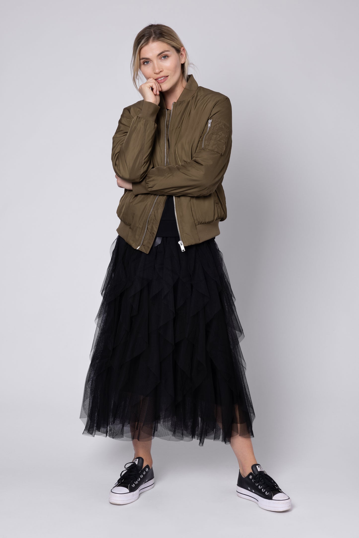 model wearing black tulle skirt and khaki bomber jacket