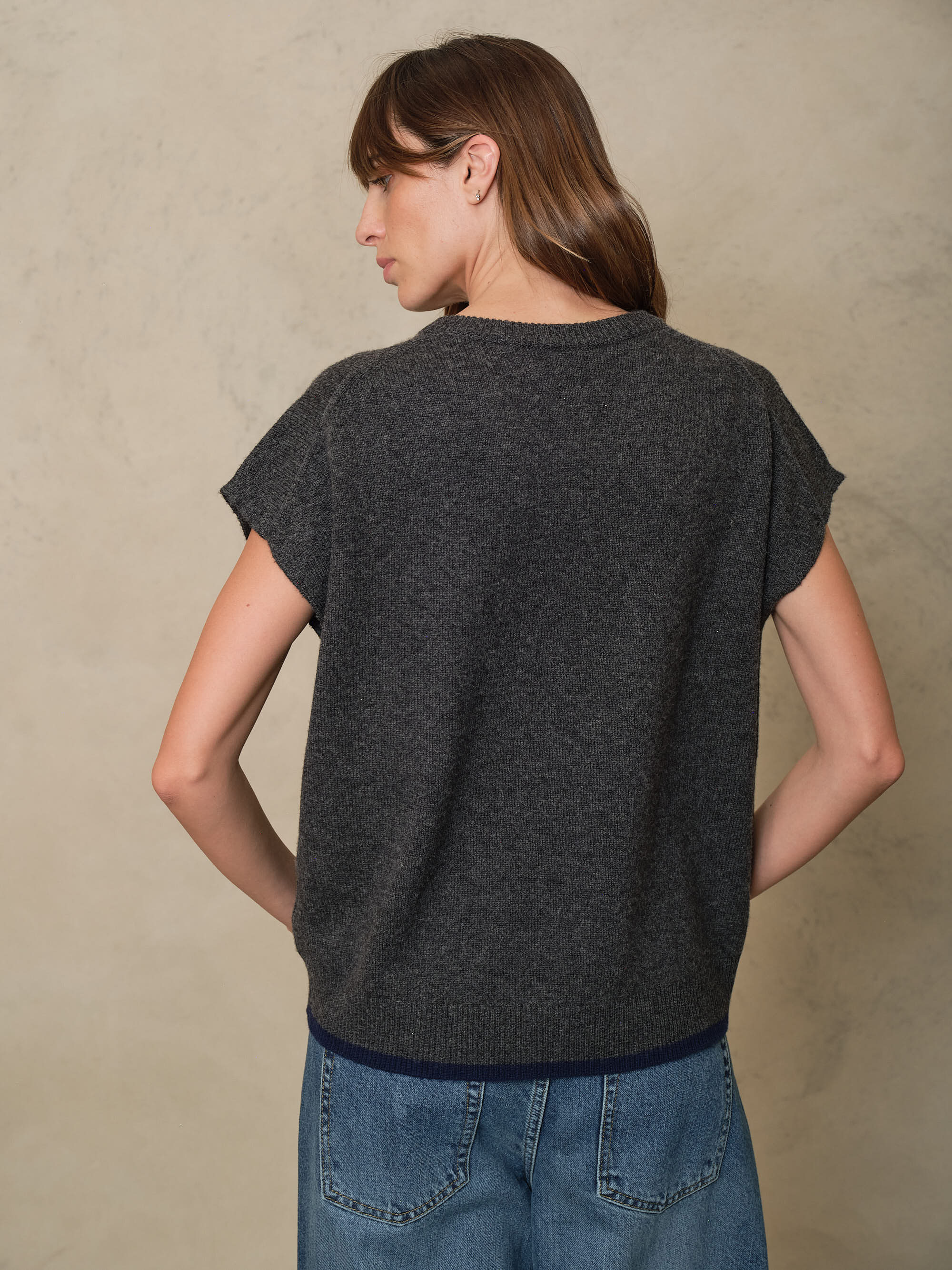 Back view of the Ora charcoal knitted vest showing the dropped shoulder and boxy fit
