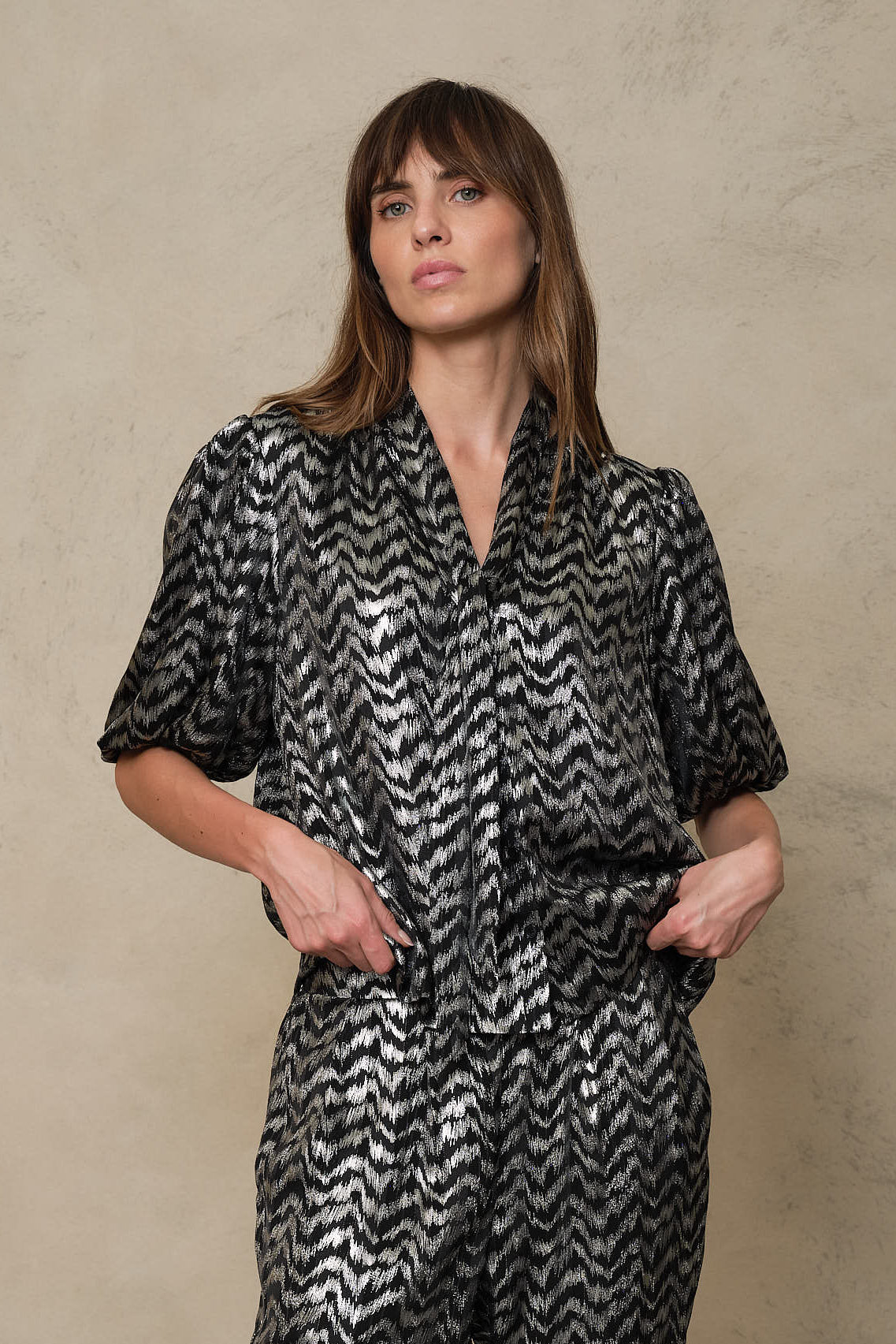 Poppy silver stripe blouse with matching trousers and a hand in the pocket